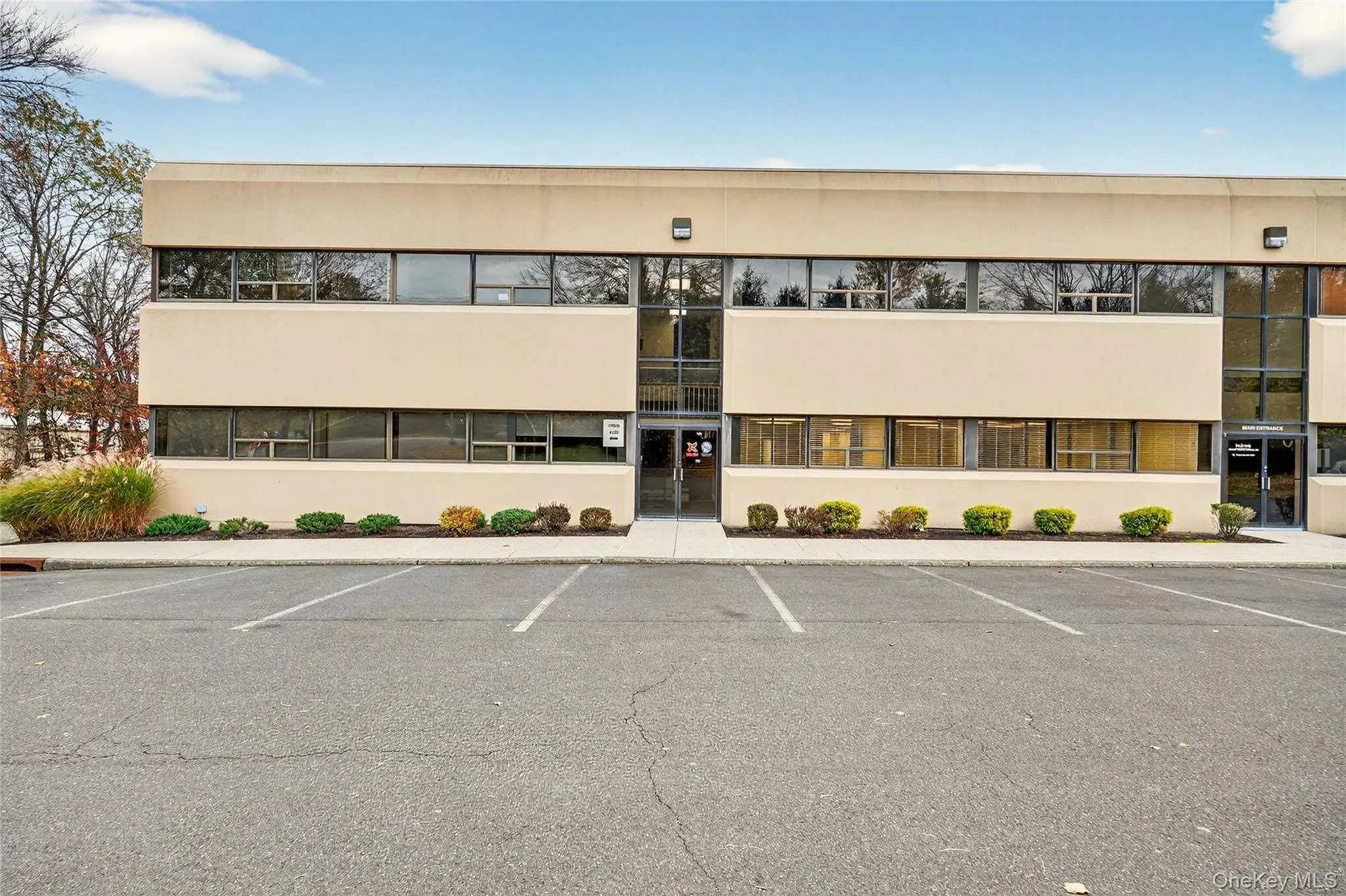 View of property with uncovered parking View of property with uncovered parking