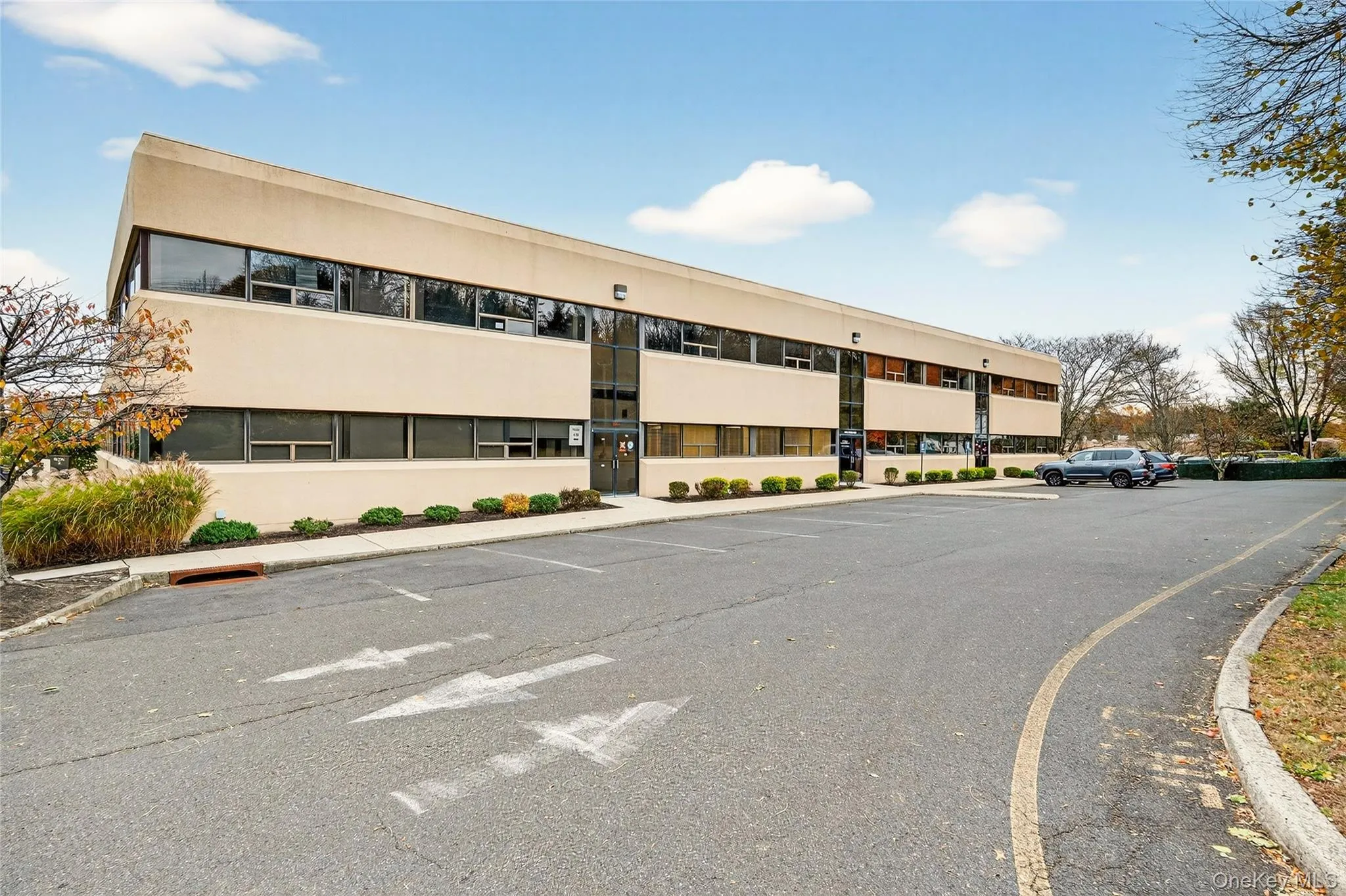 View of apartment building / complex with uncovered parking View of apartment building / complex with uncovered parking