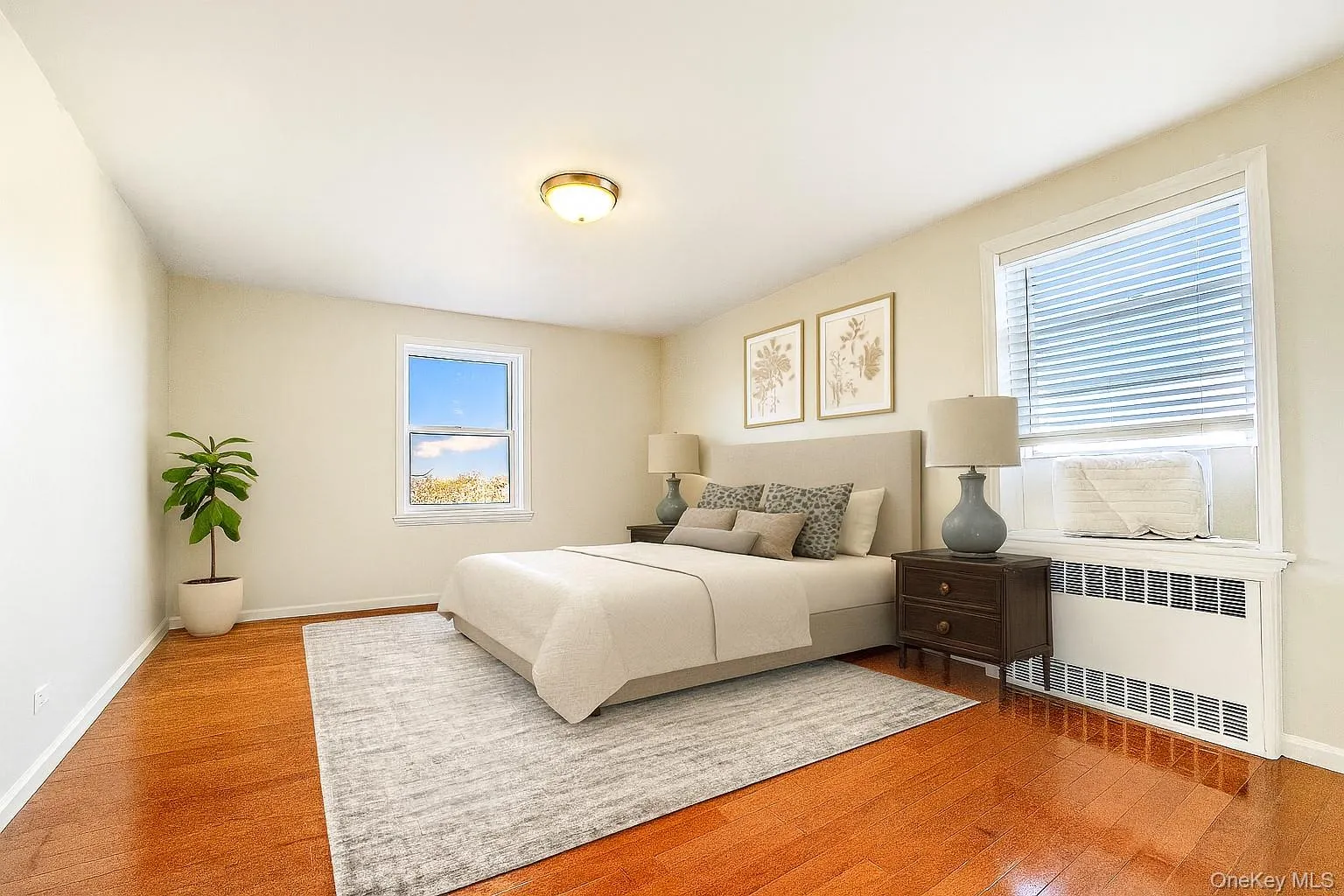 Bedroom featuring light wood-type flooring and radiator Bedroom featuring light wood-type flooring and radiator