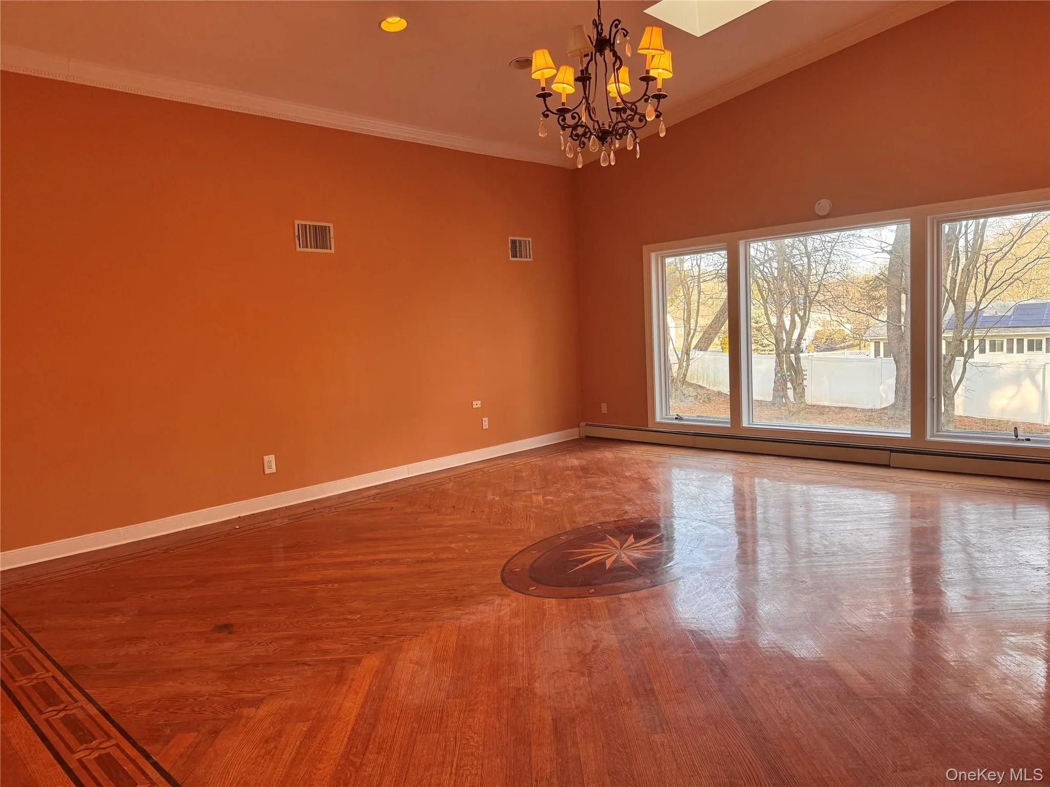 Spare room featuring a chandelier, crown molding, a baseboard radiator, and recessed lighting Spare room featuring a chandelier, crown molding, a baseboard radiator, and recessed lighting