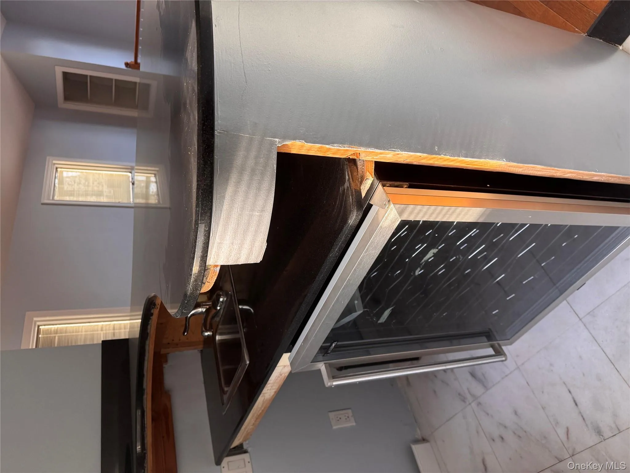 Kitchen view of wine cooler and a sink Kitchen view of wine cooler and a sink