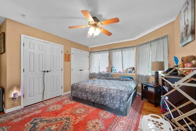 Bedroom with multiple closets and a ceiling fan Bedroom with multiple closets and a ceiling fan