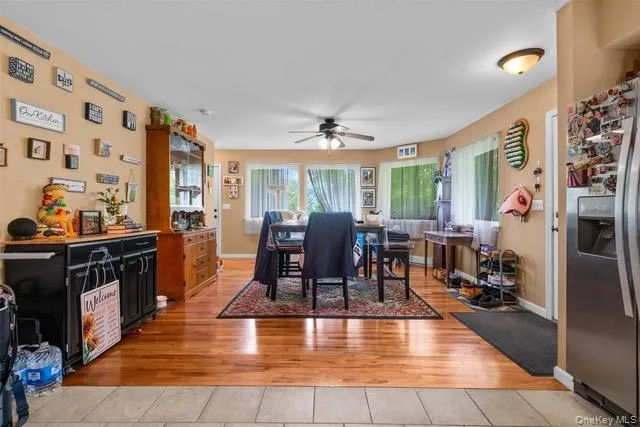Dining room with light wood-type flooring and ceiling fan Dining room with light wood-type flooring and ceiling fan