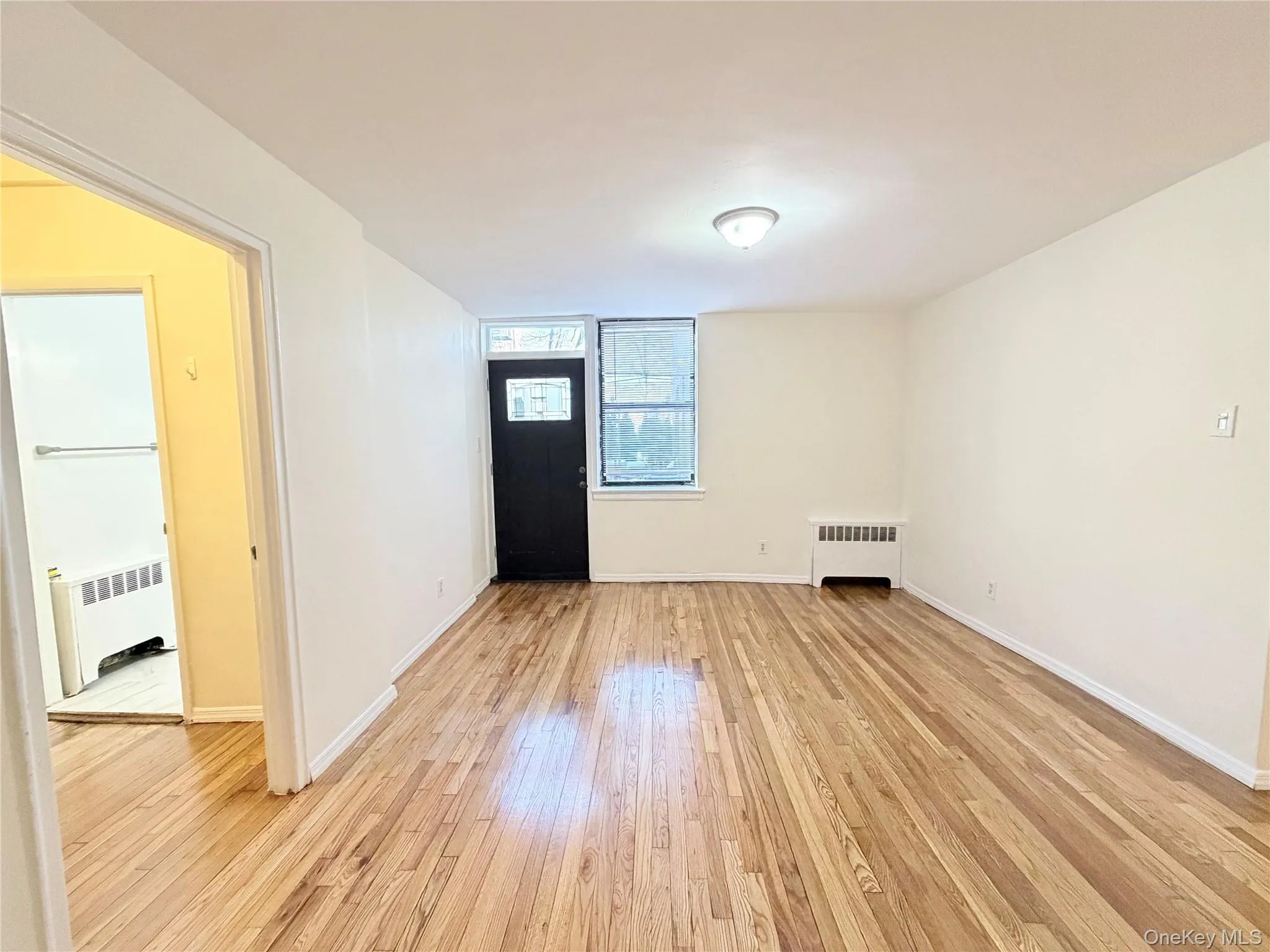 Entryway with light wood-type flooring and radiator Entryway with light wood-type flooring and radiator