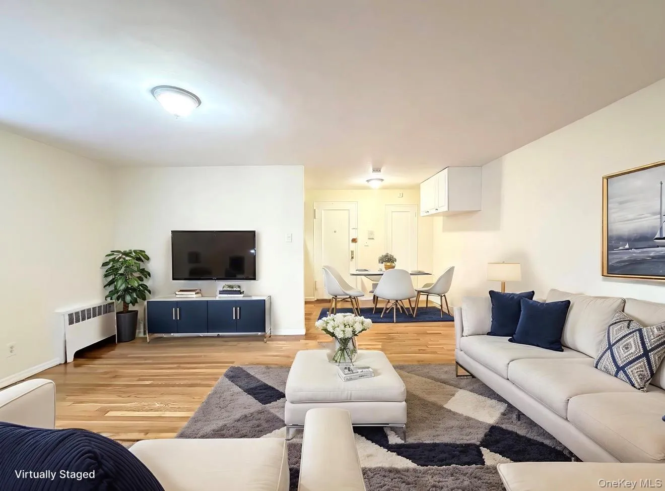 Living area featuring radiator and wood finished floors Living area featuring radiator and wood finished floors