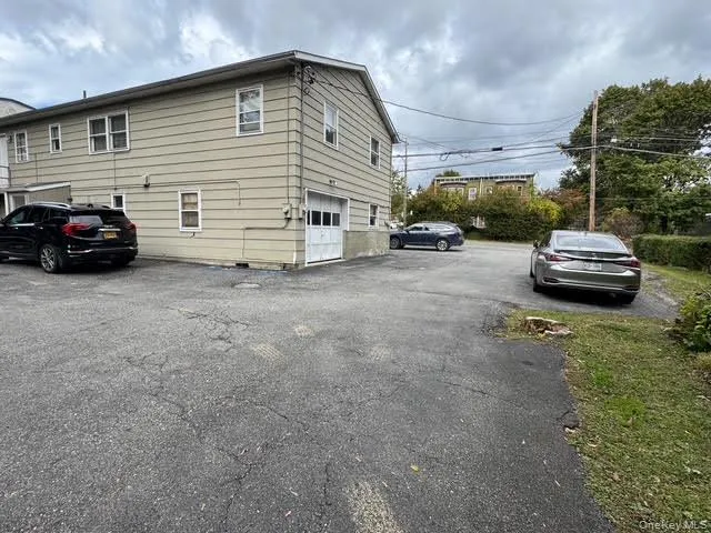 View of side of property with driveway and a garage View of side of property with driveway and a garage