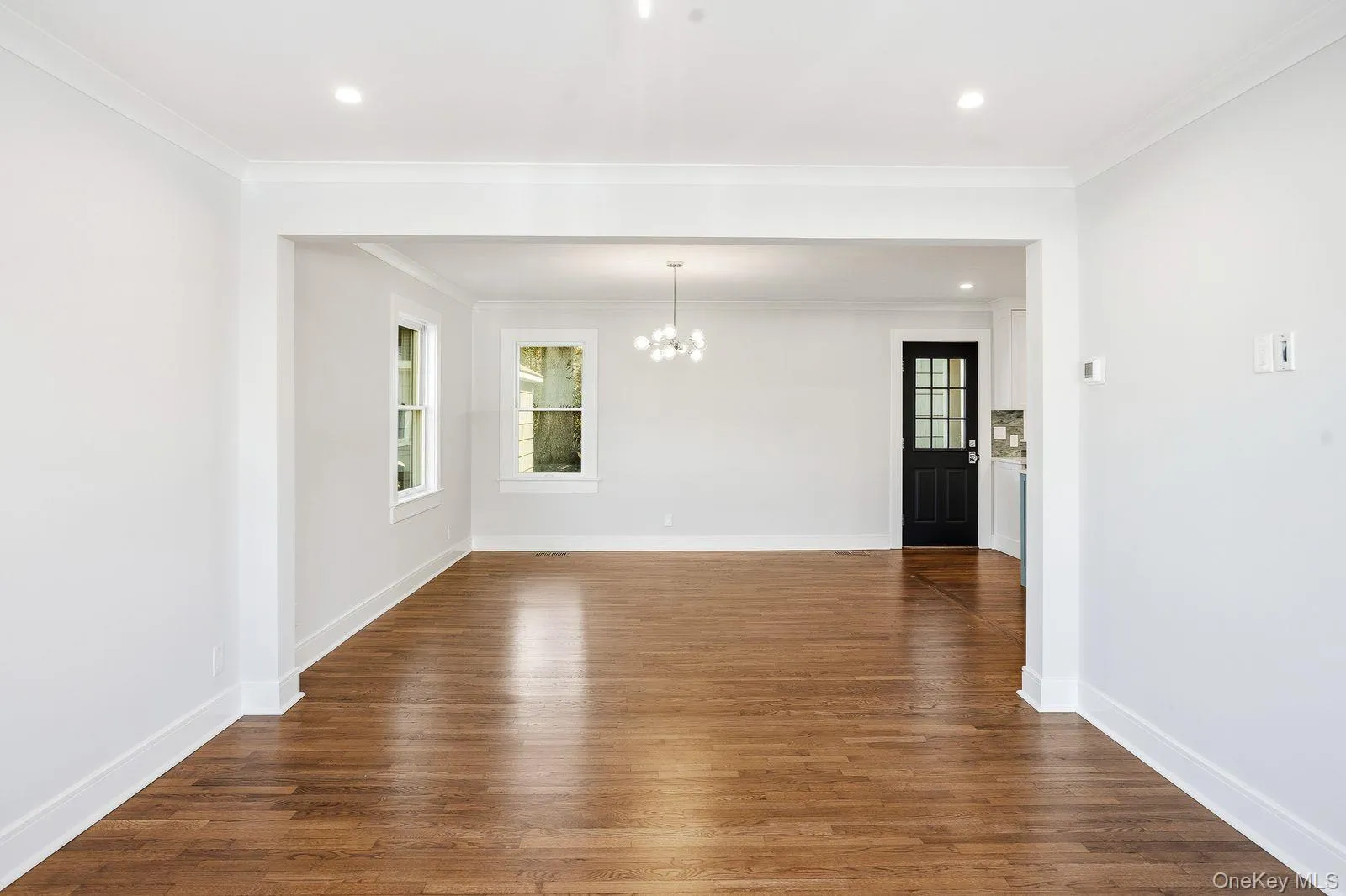 Living area facing into dining area and back door to porch Living area facing into dining area and back door to porch