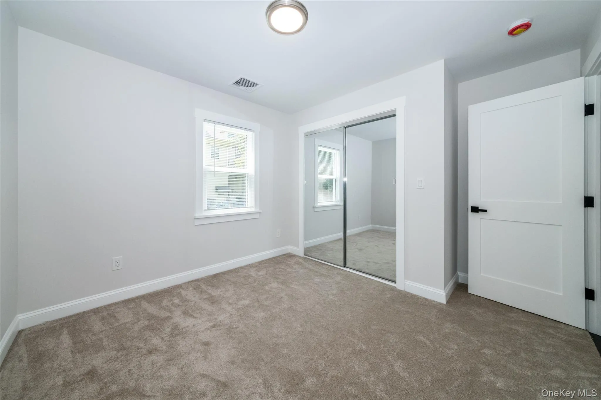 Unfurnished bedroom featuring carpet floors and a closet Unfurnished bedroom featuring carpet floors and a closet