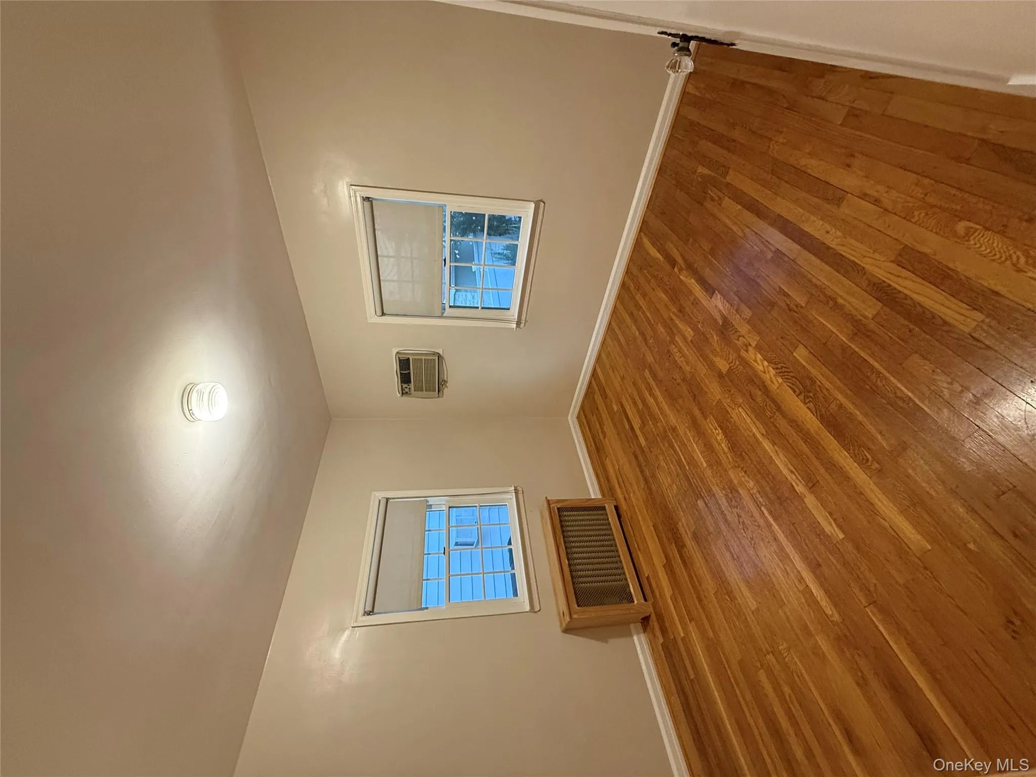 Spare room with wood-type flooring and radiator heating unit Spare room with wood-type flooring and radiator heating unit