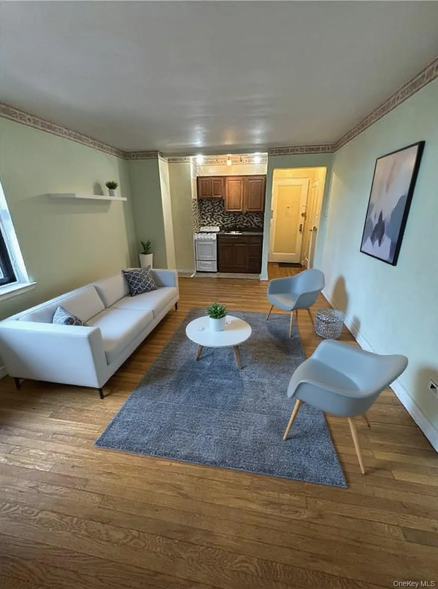 Living area with light wood finished floors and baseboards Living area with light wood finished floors and baseboards