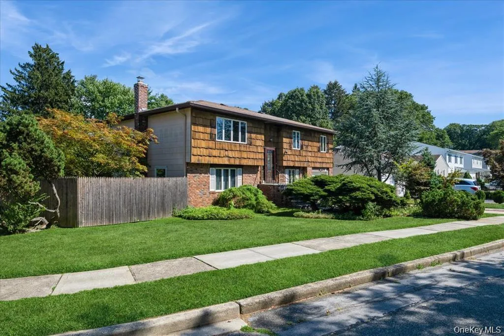 View of front of house featuring brick siding and a chimney View of front of house featuring brick siding and a chimney