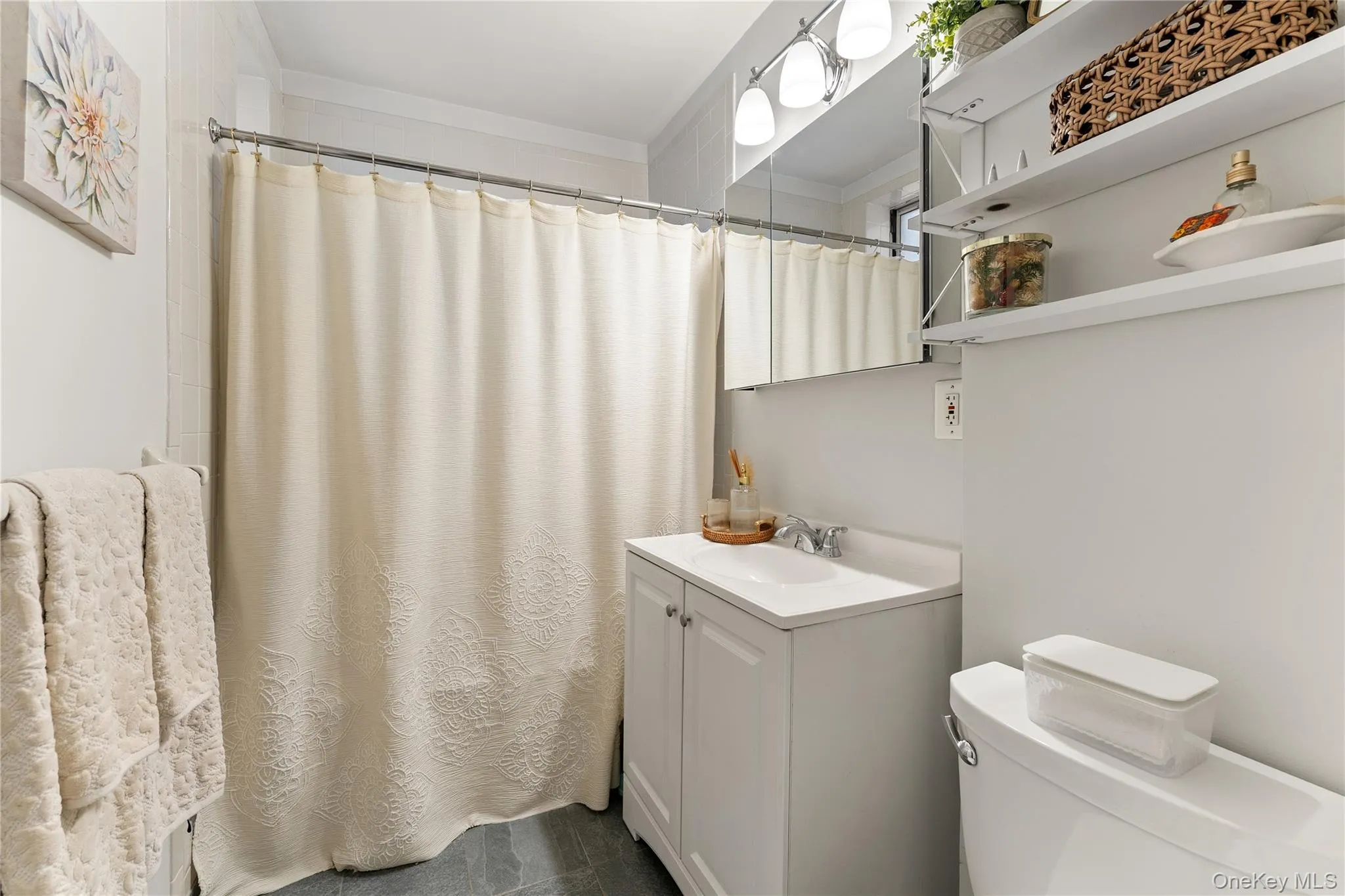 Renovated bathroom (2018) with ceramic tile and modern fixtures Renovated bathroom (2018) with ceramic tile and modern fixtures