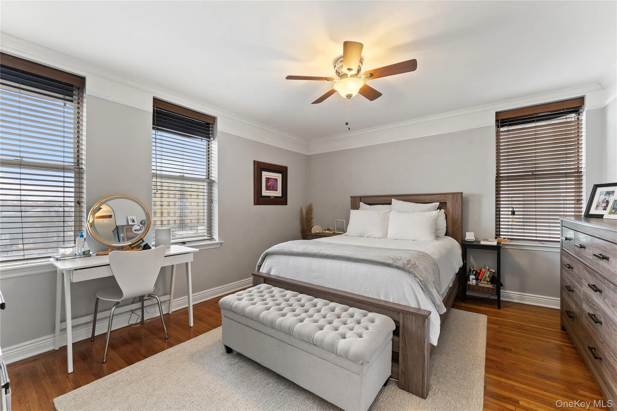 Large, bright bedroom with windows on two walls, refinished hardwood floors (2018), and ample closet space, viewed from hallway Large, bright bedroom with windows on two walls, refinished hardwood floors (2018), and ample closet space, viewed from hallway