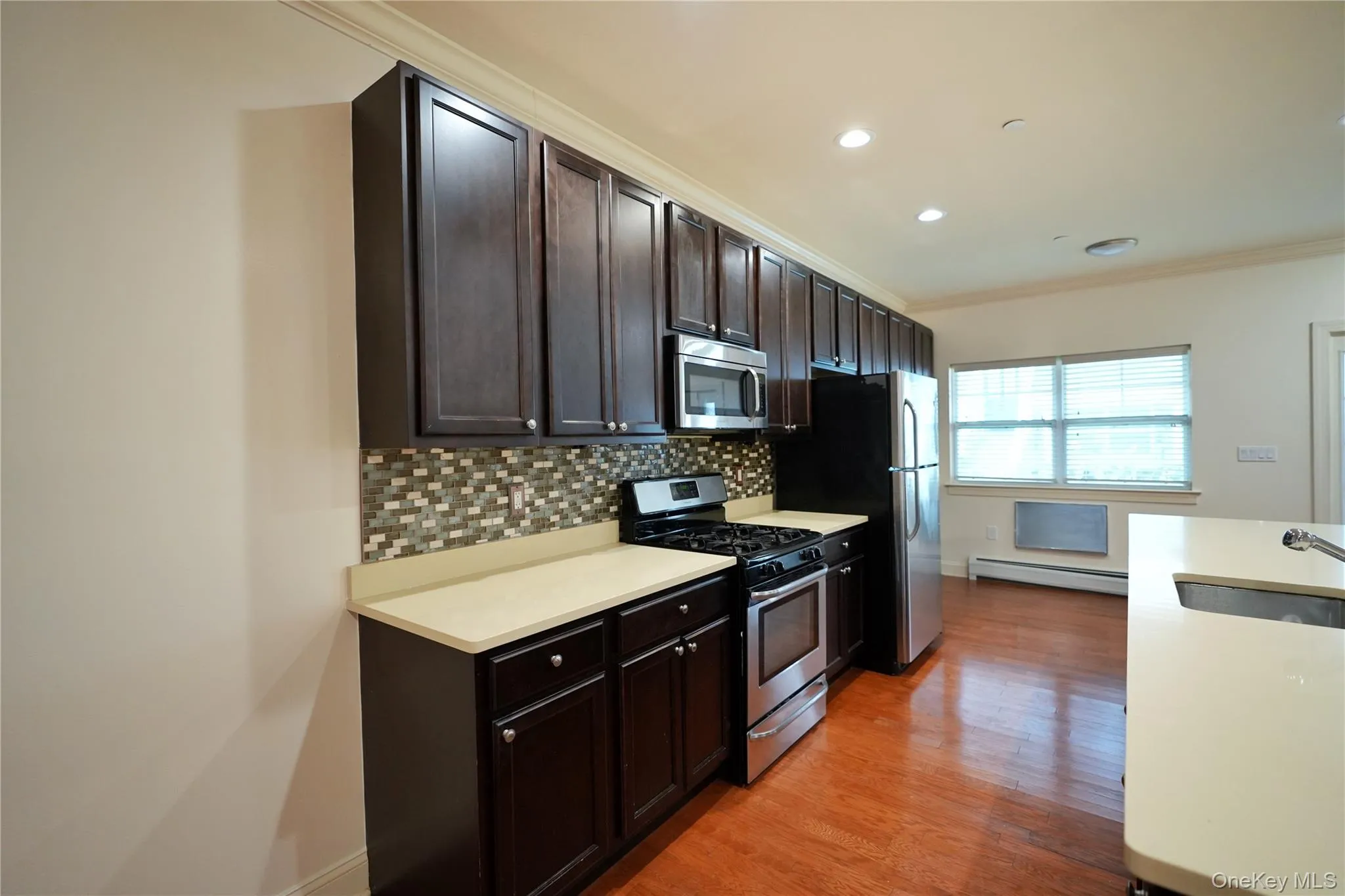 Kitchen island w/ dishwasher and sink (dishwasher not photographed, located next to sink). Kitchen island w/ dishwasher and sink (dishwasher not photographed, located next to sink).