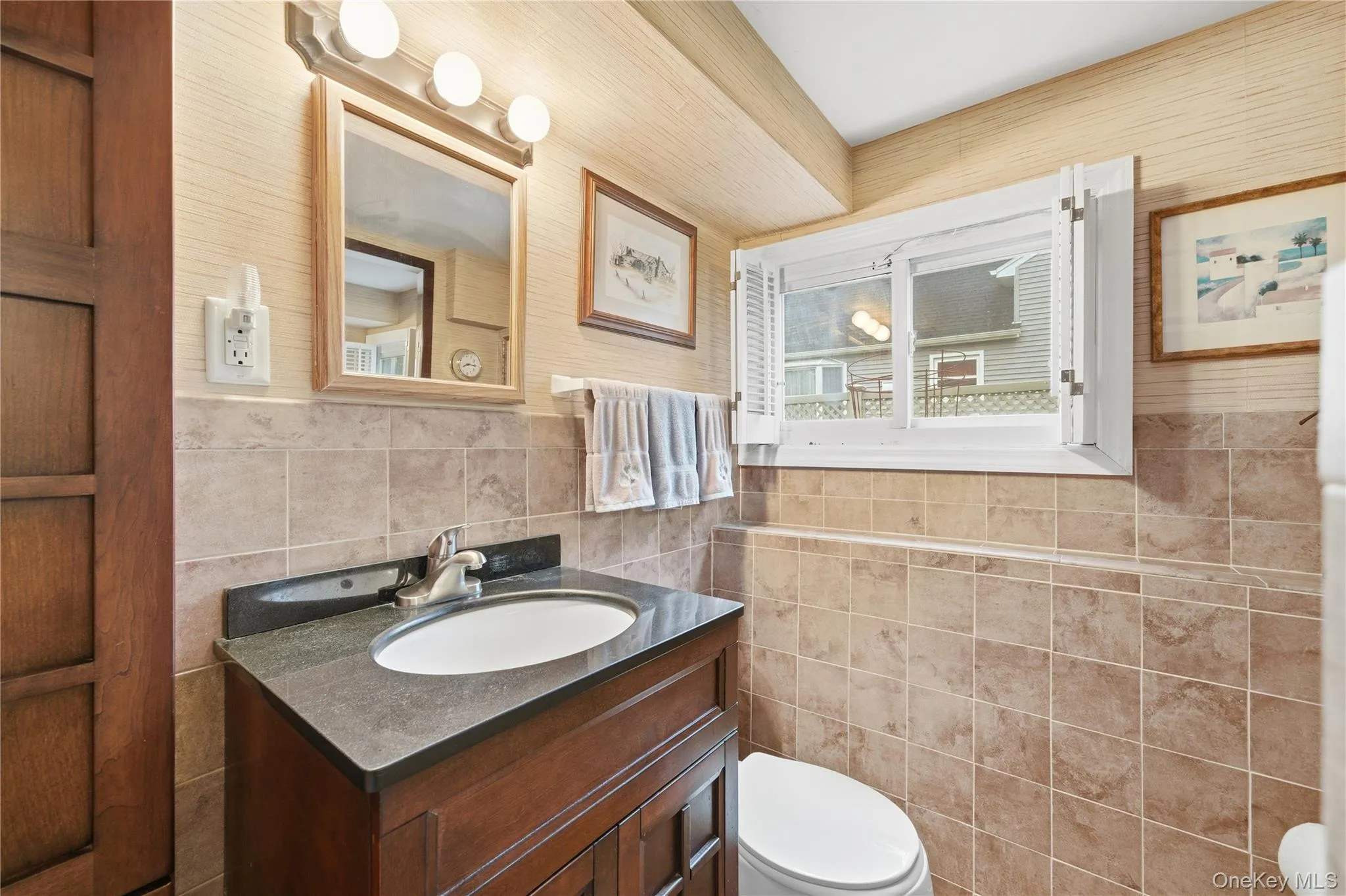 Half bathroom with vanity and tile walls Half bathroom with vanity and tile walls