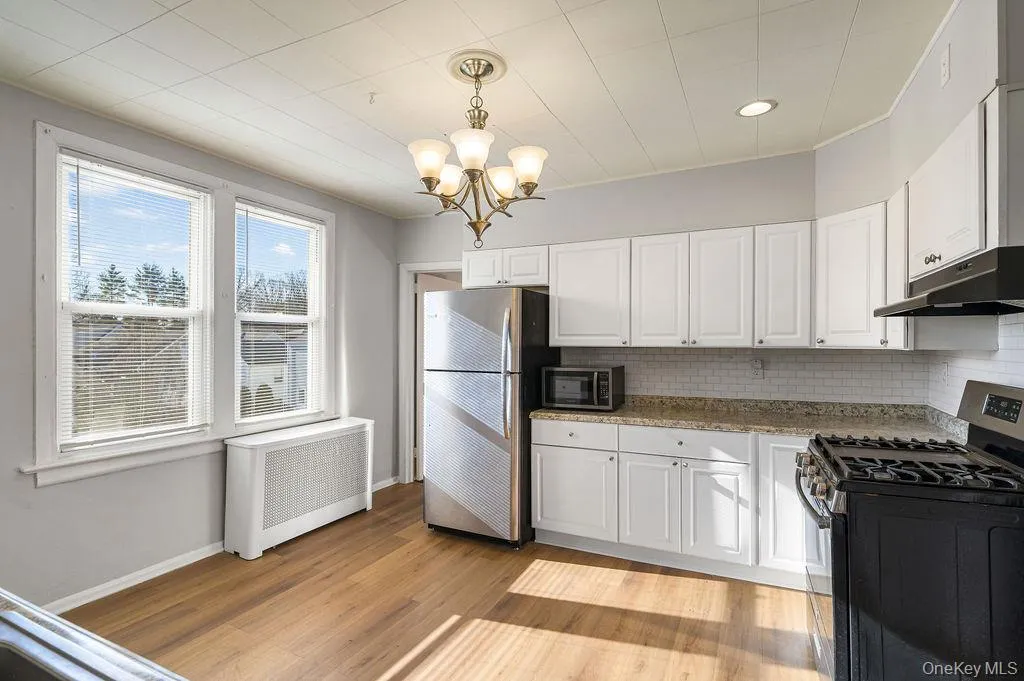 Sun filled, large kitchen with an abundace of cabinets for storage Sun filled, large kitchen with an abundace of cabinets for storage