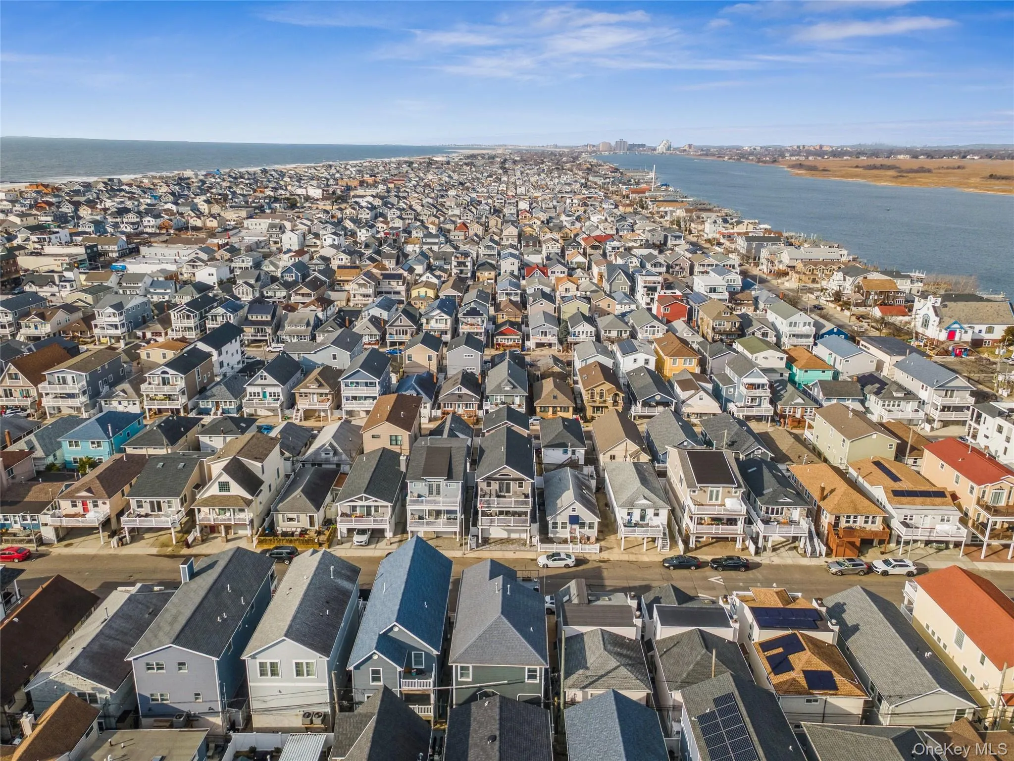 Aerial perspective of suburban area featuring a nearby body of water Aerial perspective of suburban area featuring a nearby body of water
