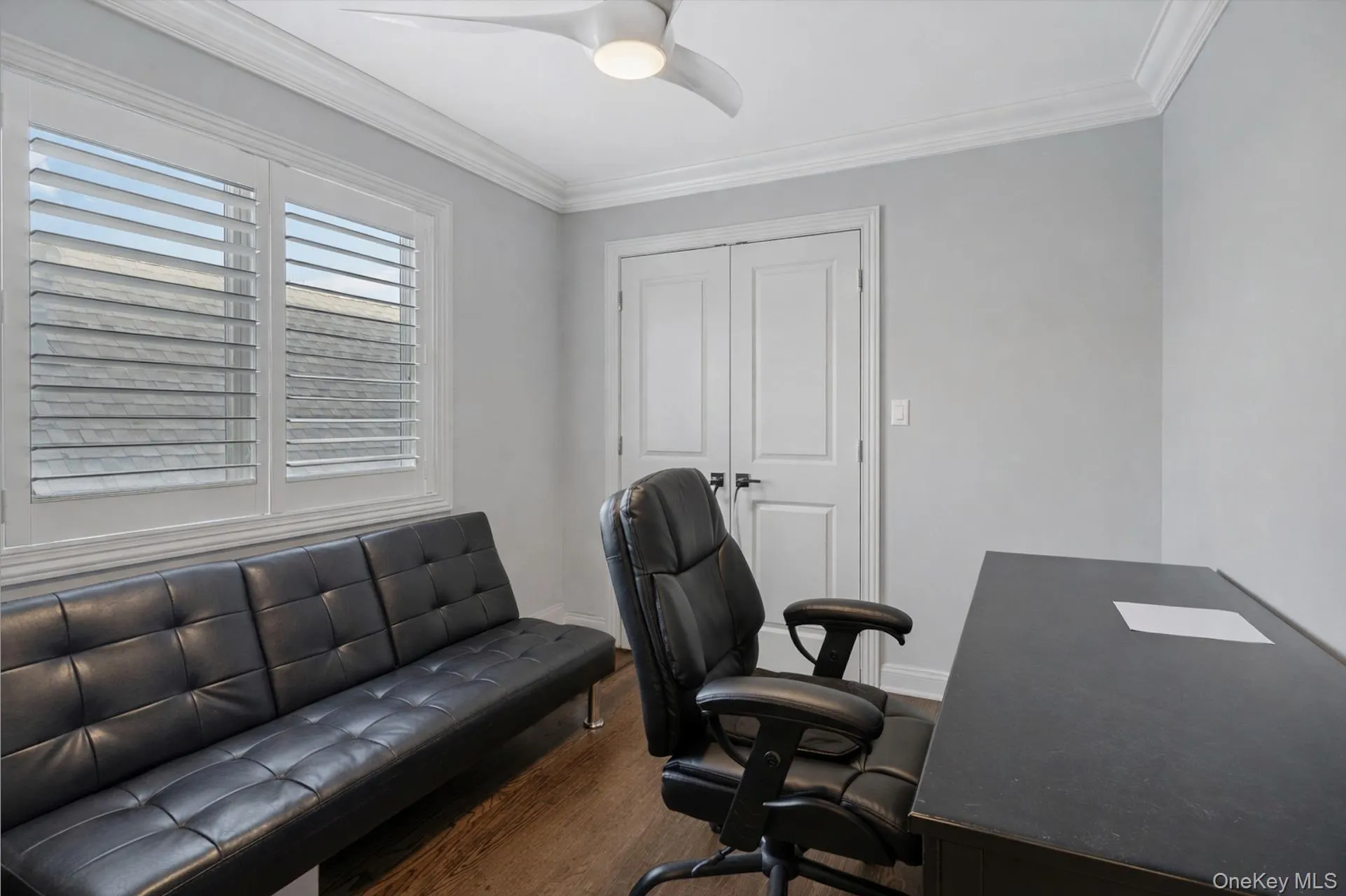 Office with crown molding, dark wood-style floors, and a ceiling fan Office with crown molding, dark wood-style floors, and a ceiling fan