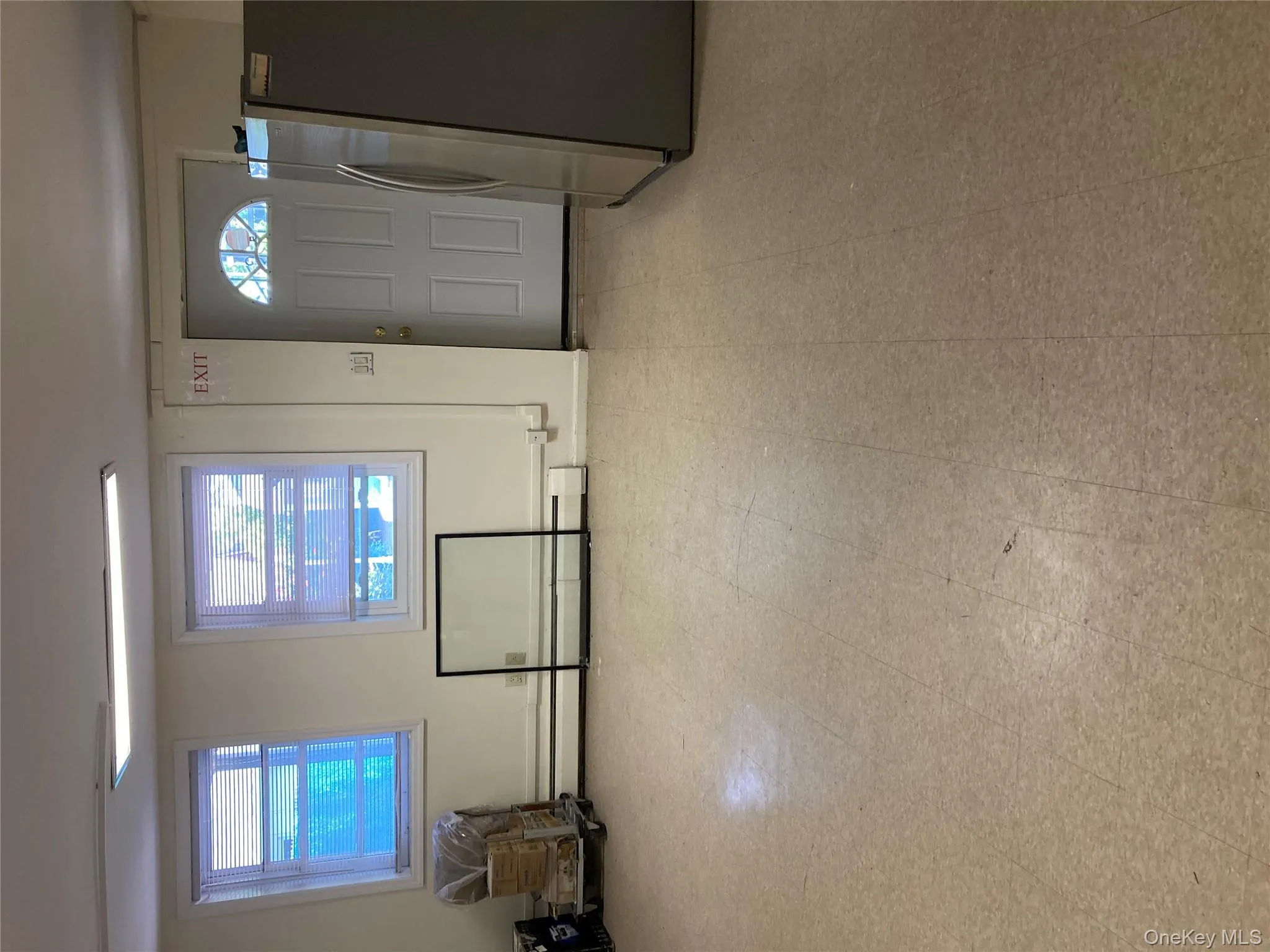 Entryway with plenty of natural light, a baseboard radiator, and tile patterned floors Entryway with plenty of natural light, a baseboard radiator, and tile patterned floors