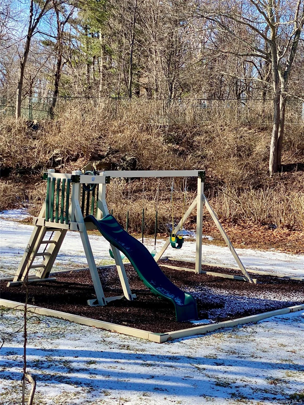 A fenced in playground A fenced in playground