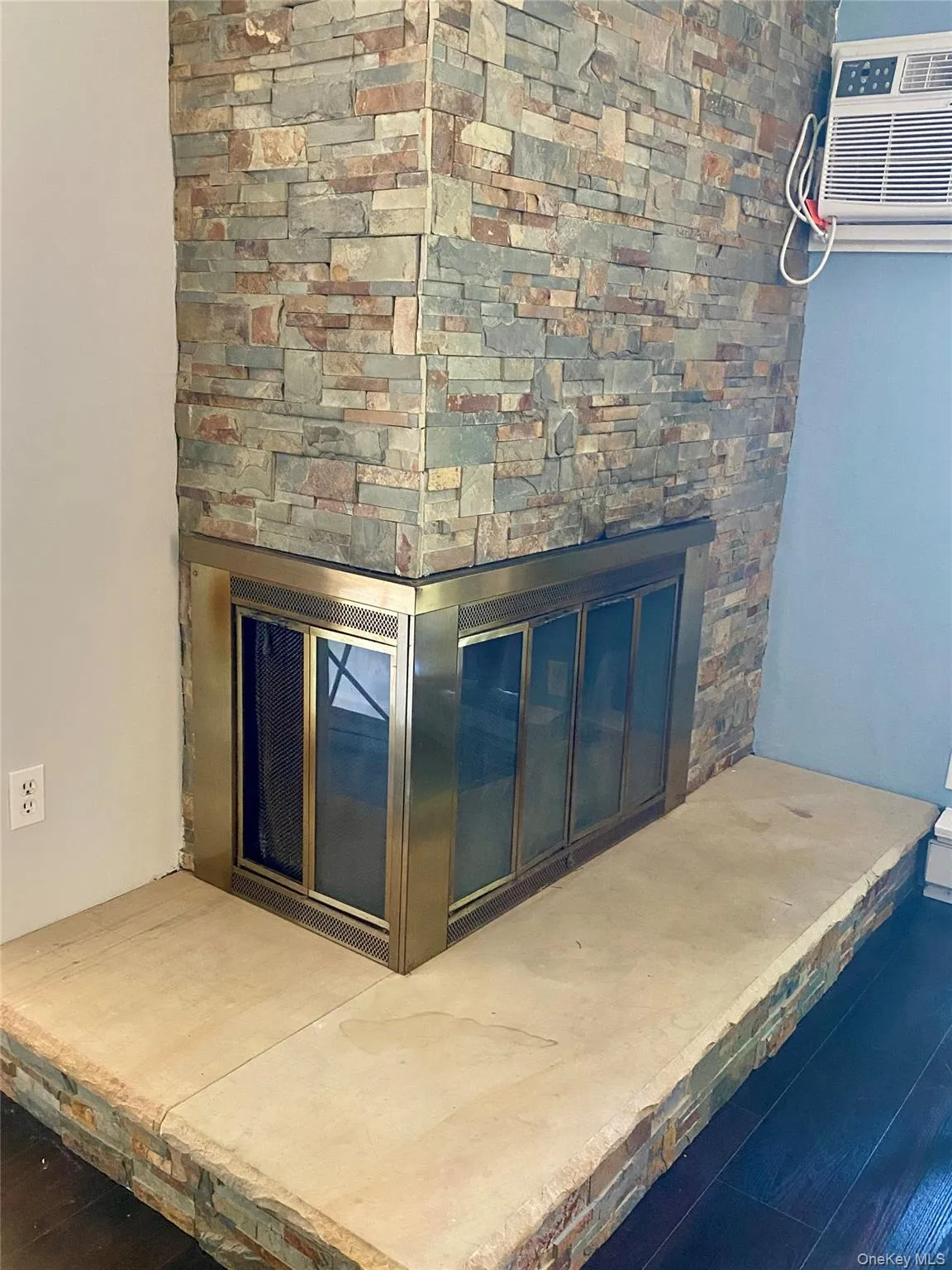 A corner wood burning fireplace in the Living Room A corner wood burning fireplace in the Living Room