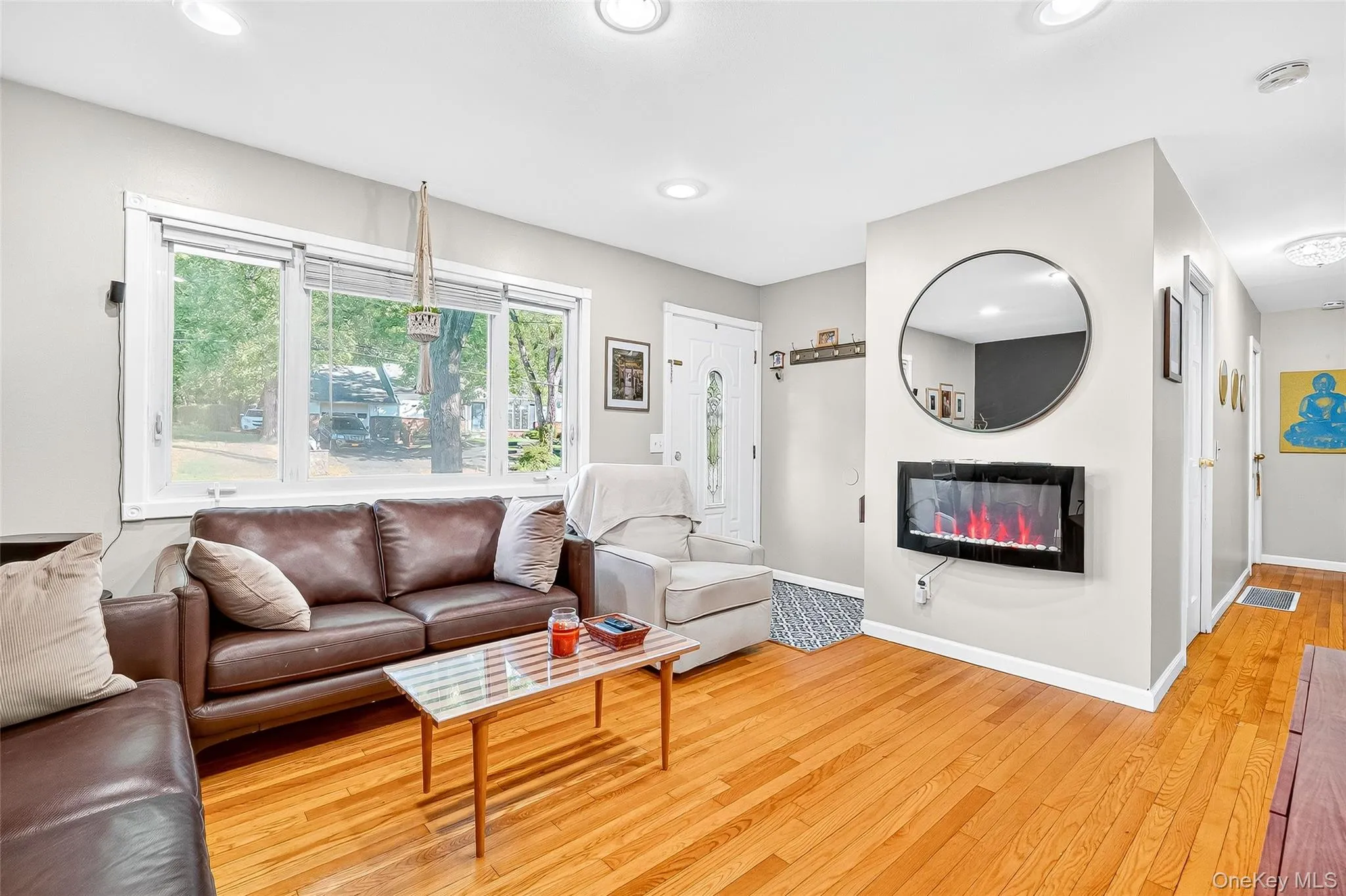 Comfortable entry, living area with wood flooring, and recessed lighting Comfortable entry, living area with wood flooring, and recessed lighting