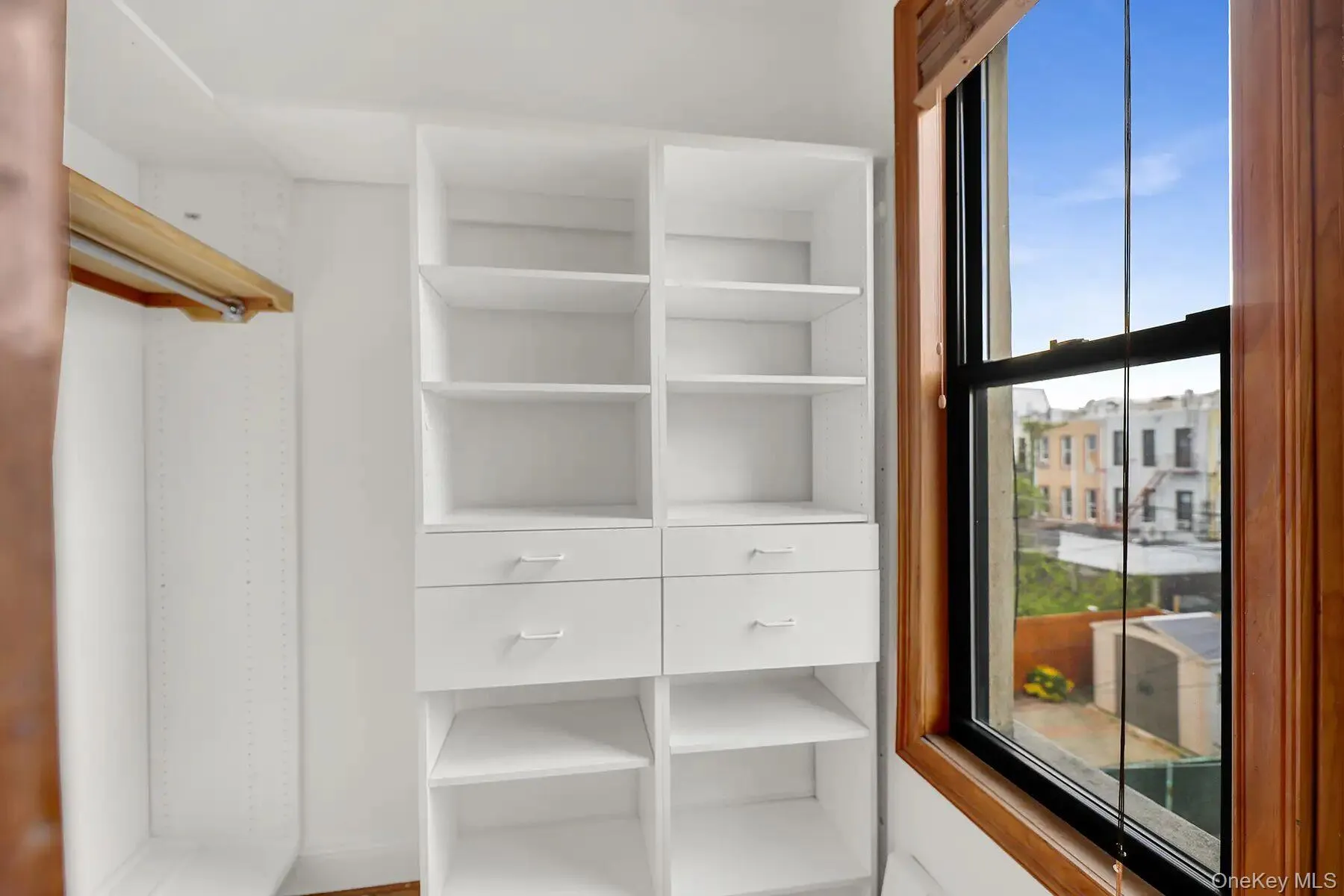 Built-in closet system with adjustable shelving and four drawers Built-in closet system with adjustable shelving and four drawers