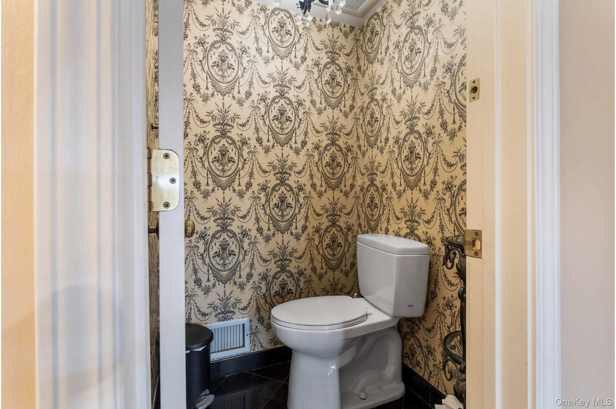 Bathroom featuring toilet and tile patterned flooring Bathroom featuring toilet and tile patterned flooring