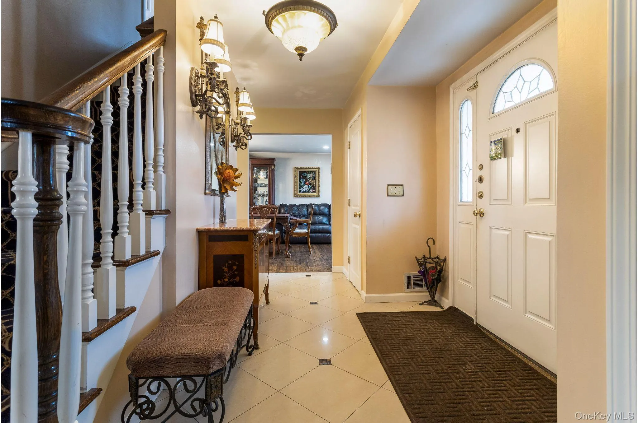 Entrance foyer featuring light tile patterned floors and stairs Entrance foyer featuring light tile patterned floors and stairs