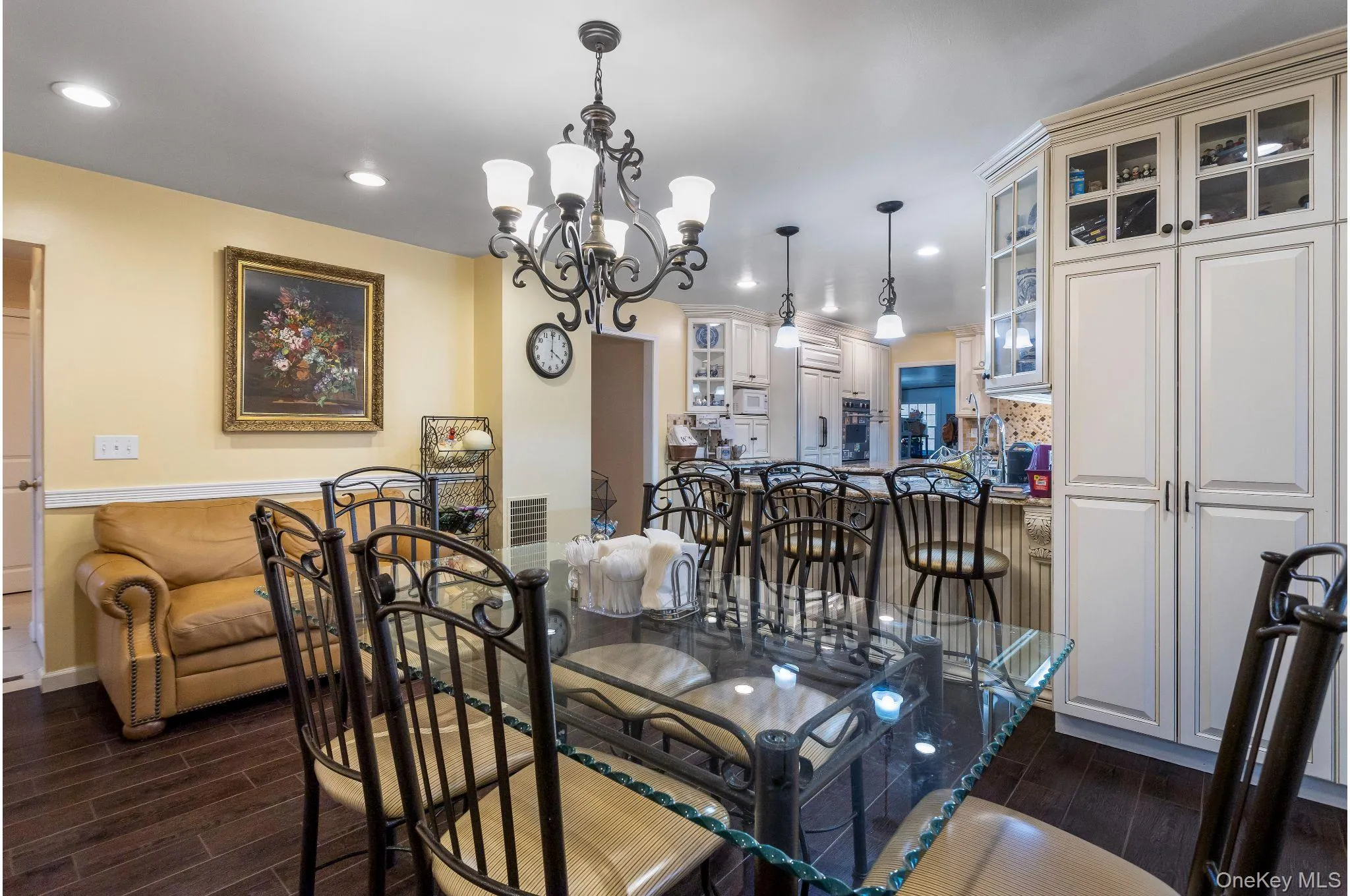 Dining space with wood tiled floors, a chandelier, and recessed lighting Dining space with wood tiled floors, a chandelier, and recessed lighting