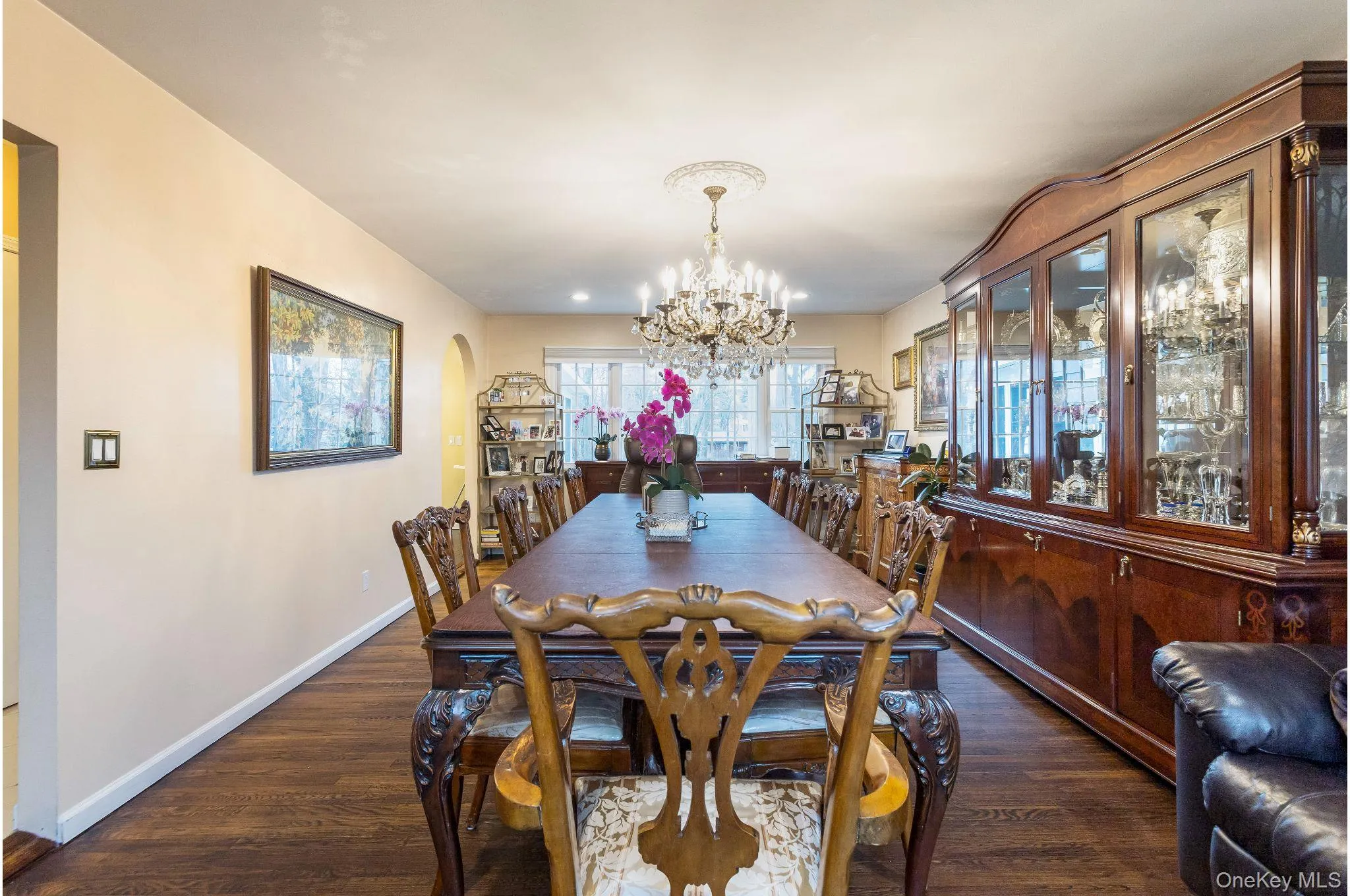 Dining room featuring dark wood-type flooring and a chandelier Dining room featuring dark wood-type flooring and a chandelier