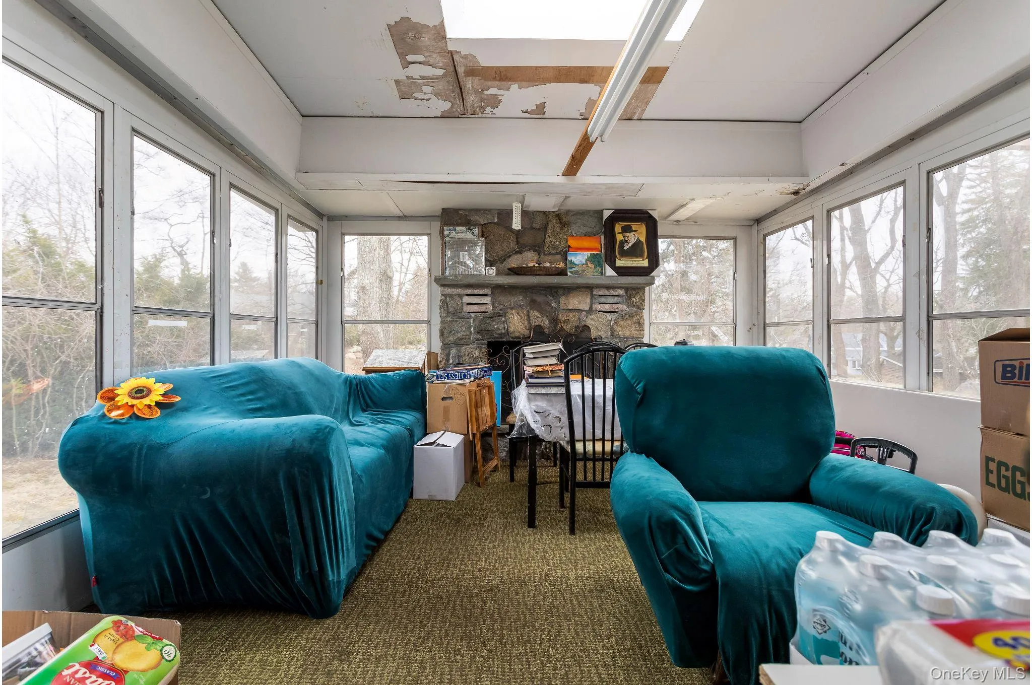 Sunroom / solarium featuring carpet flooring & fireplace Sunroom / solarium featuring carpet flooring & fireplace