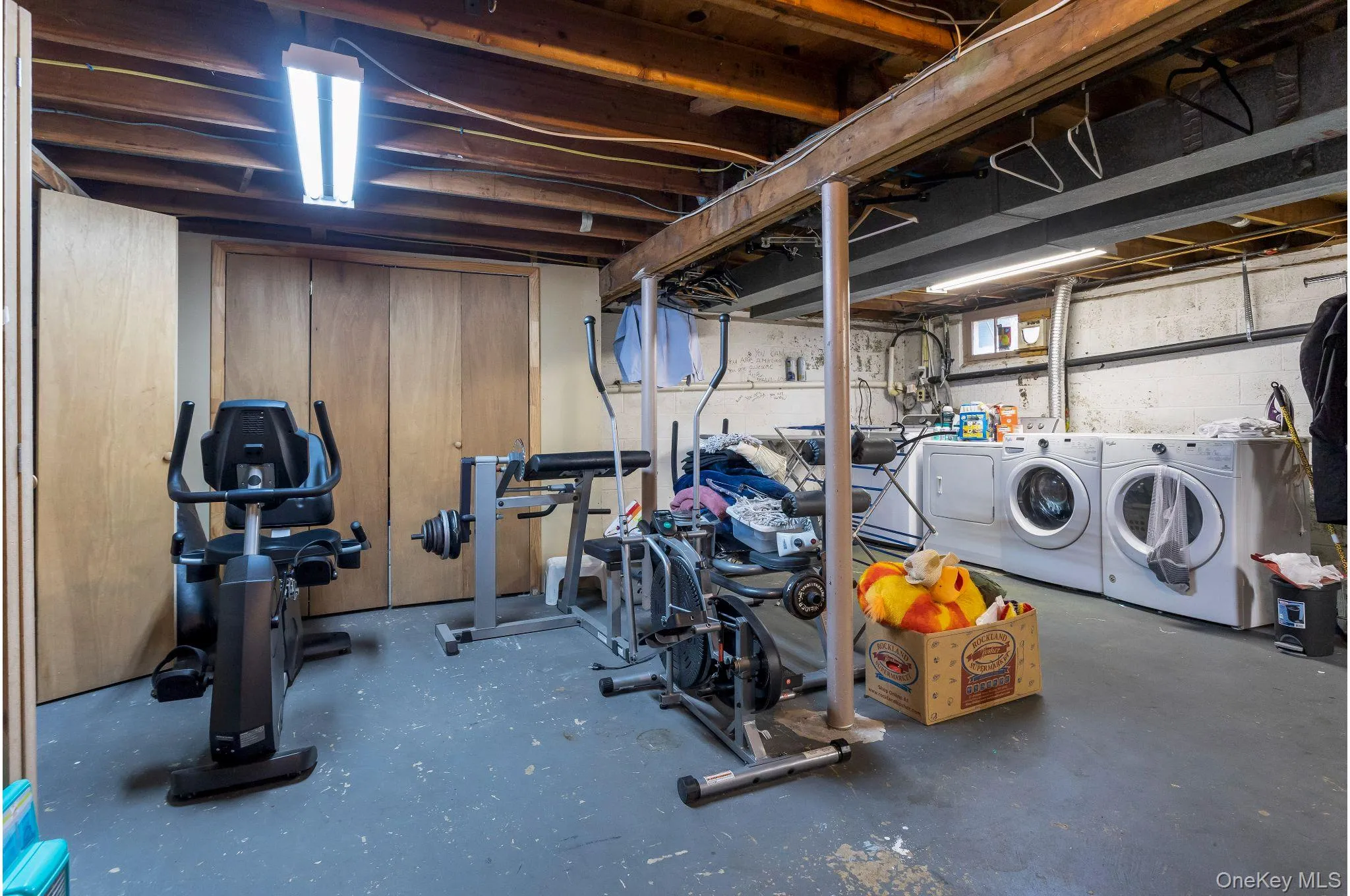 Unfinished below grade area featuring washing machine and dryer Unfinished below grade area featuring washing machine and dryer