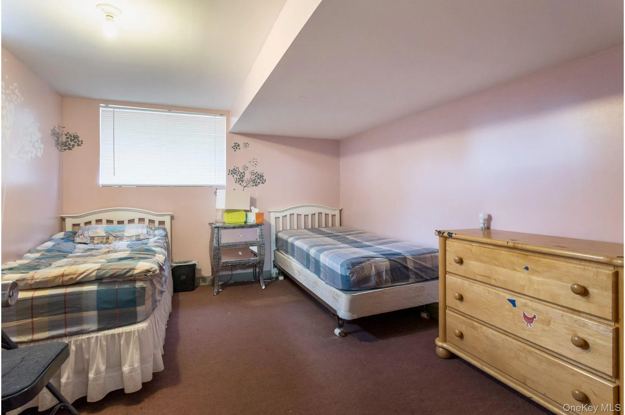 basement Bedroom with window featuring dark colored carpet basement Bedroom with window featuring dark colored carpet