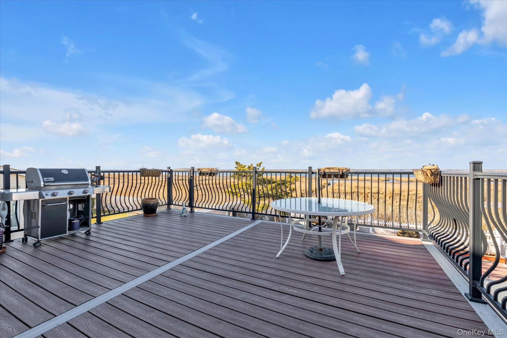 Wooden deck with water views and grilling area Wooden deck with water views and grilling area