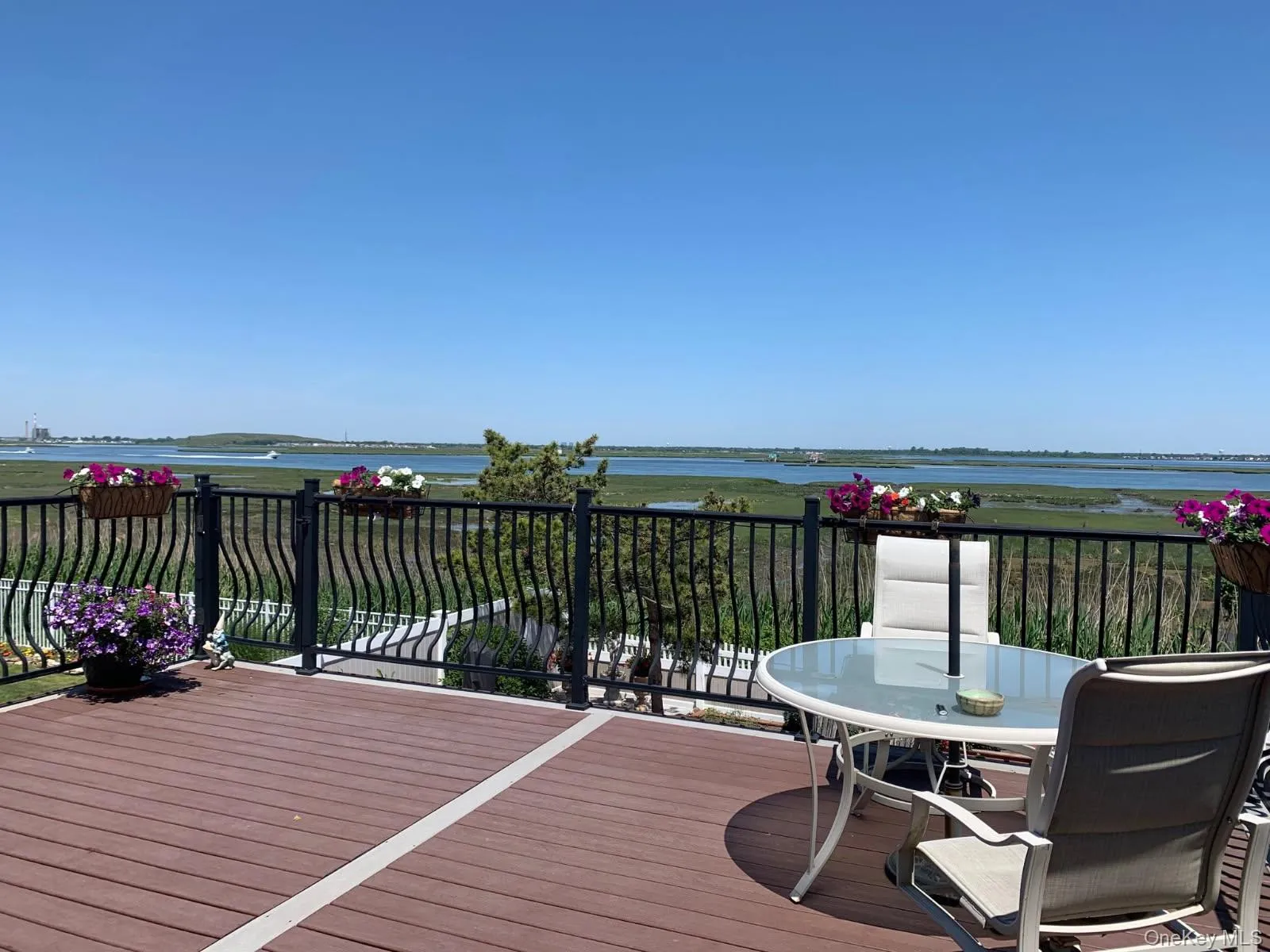 Wooden deck featuring water and city views Wooden deck featuring water and city views