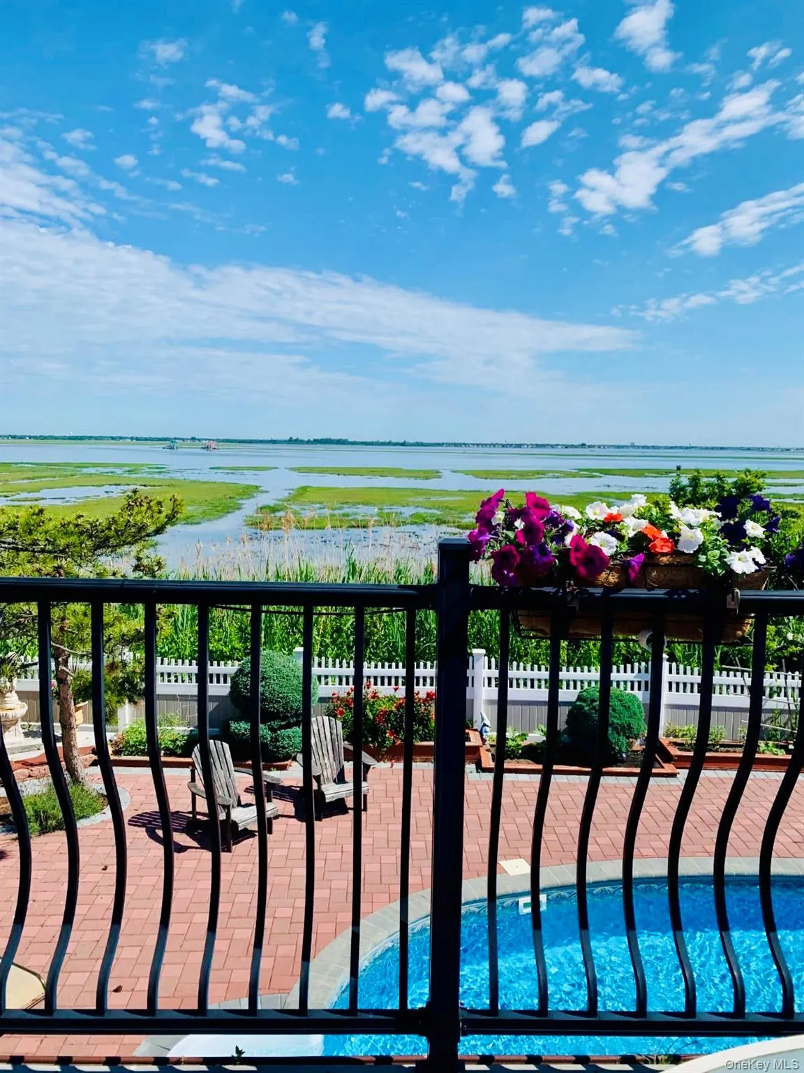 Balcony with a water view and a patio Balcony with a water view and a patio