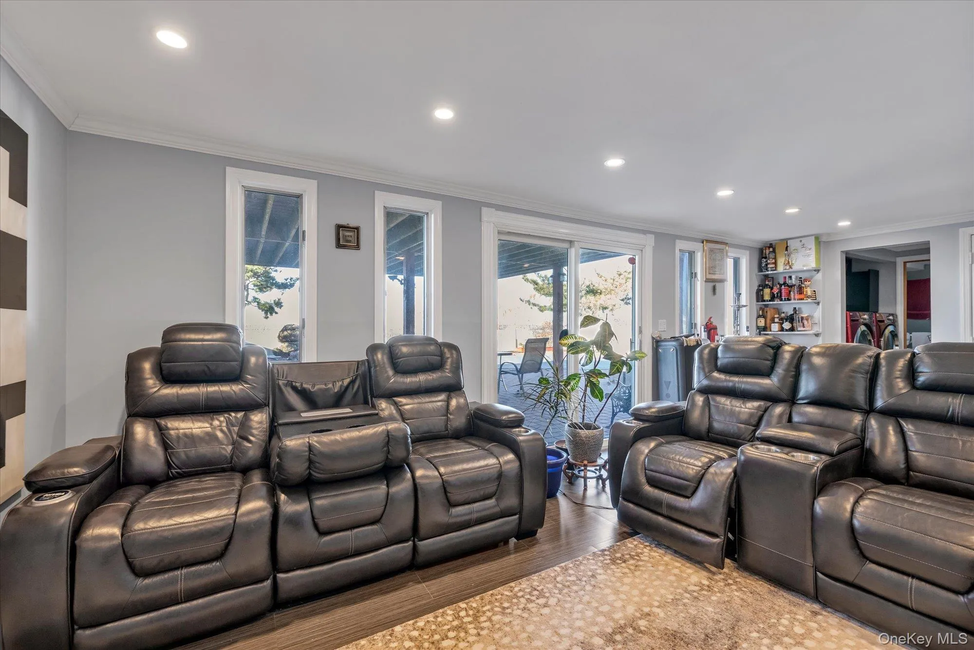 Home theater room with recessed lighting, a bar, crown molding, and wood finished floors Home theater room with recessed lighting, a bar, crown molding, and wood finished floors