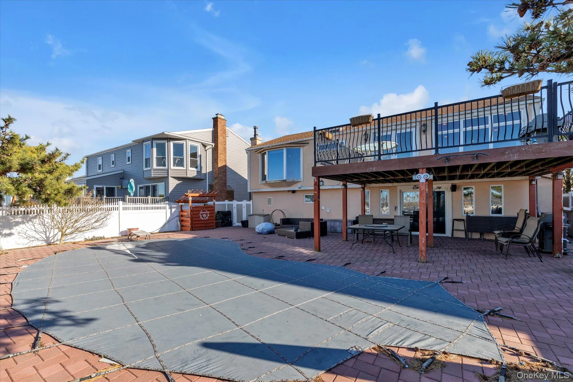 Rear view of house featuring a patio area, a fenced backyard, an outdoor living space, outdoor dining space, and a covered pool Rear view of house featuring a patio area, a fenced backyard, an outdoor living space, outdoor dining space, and a covered pool