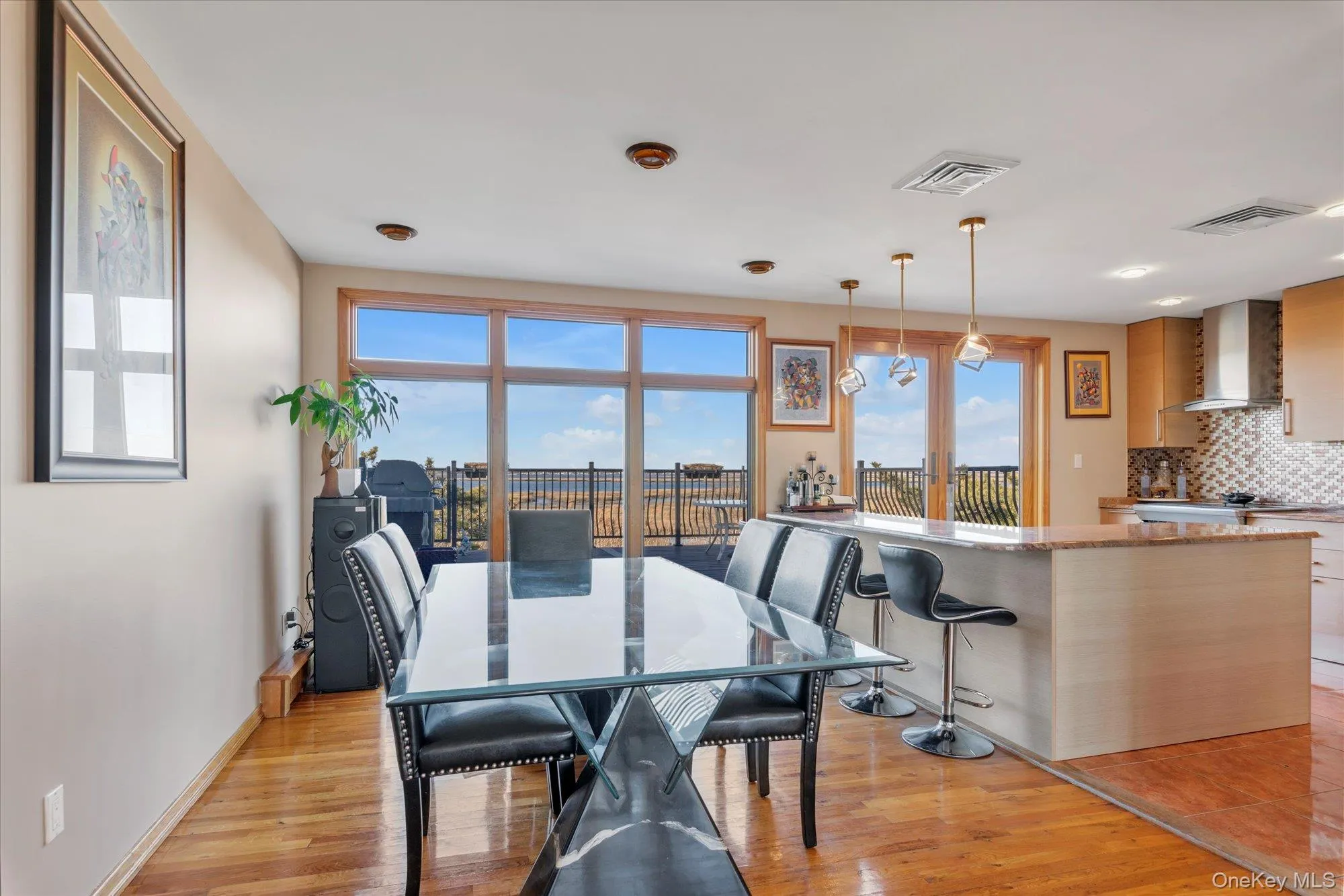 Dining space featuring water views and light wood-style floors Dining space featuring water views and light wood-style floors
