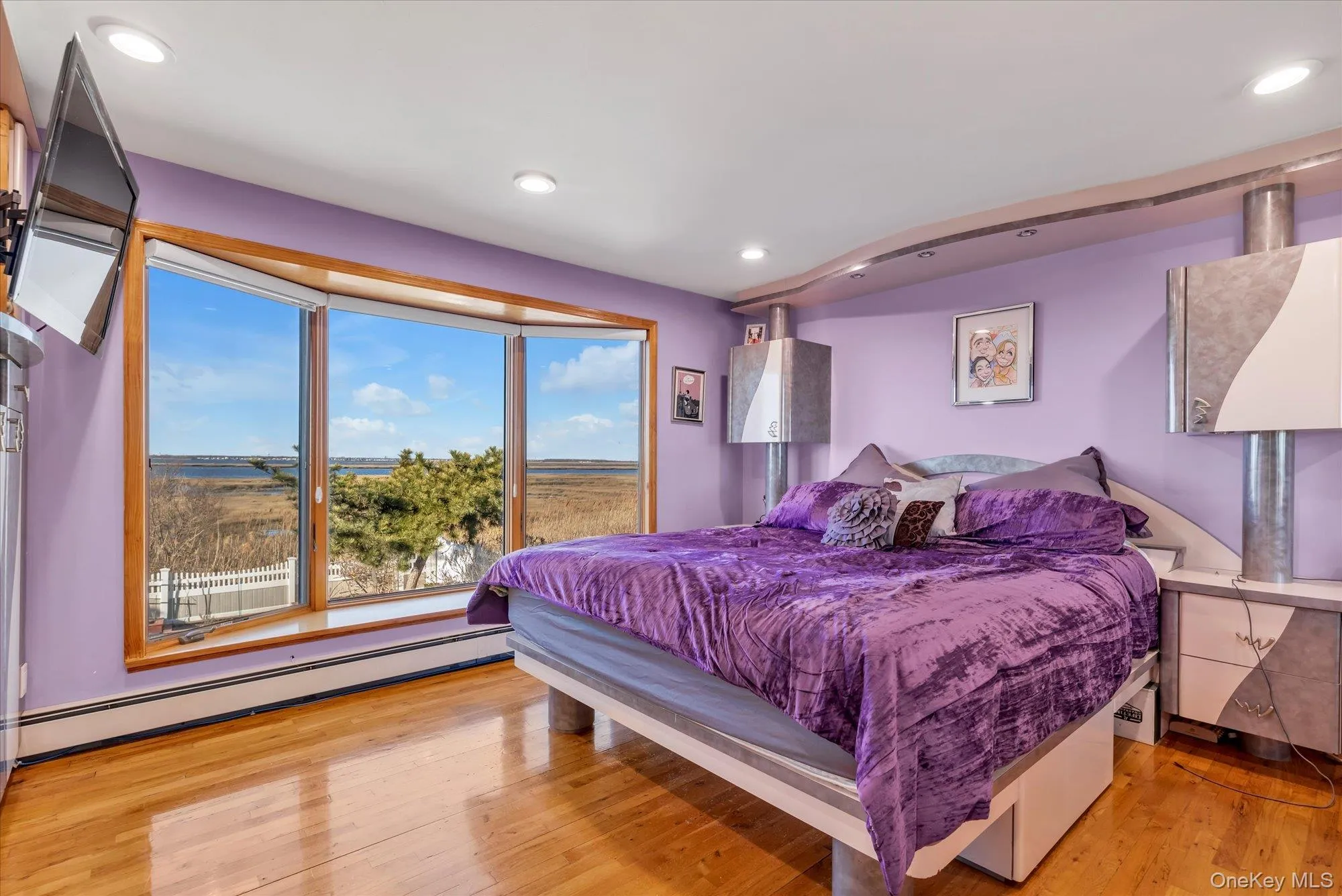 Bedroom featuring water views, light wood finished floors and recessed lighting Bedroom featuring water views, light wood finished floors and recessed lighting