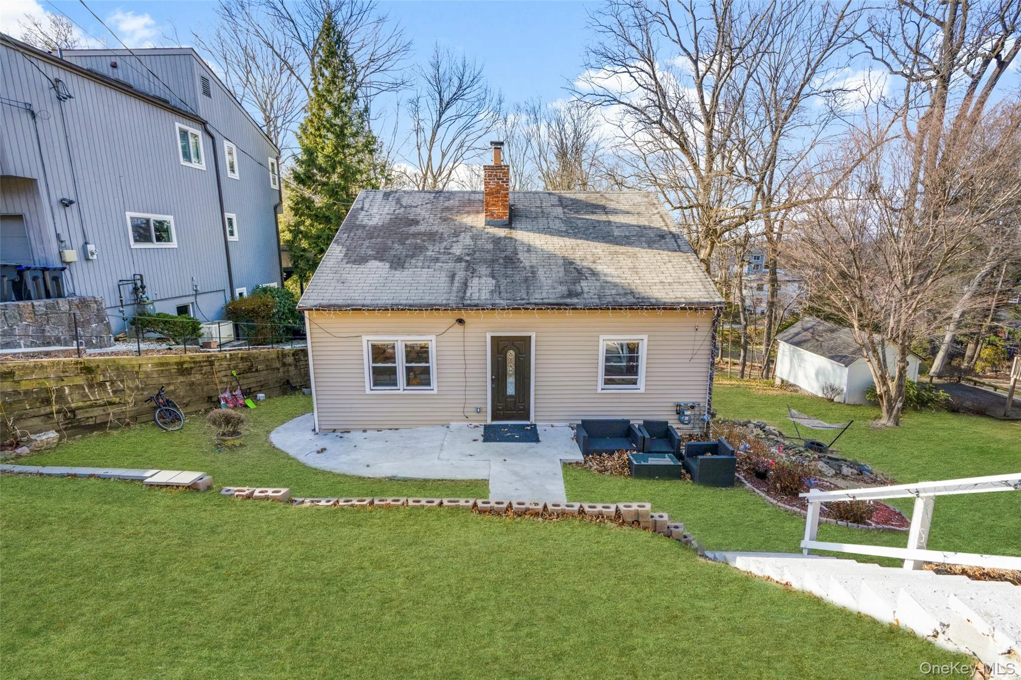Back of house with a lawn, an outdoor living space, and a patio area Back of house with a lawn, an outdoor living space, and a patio area