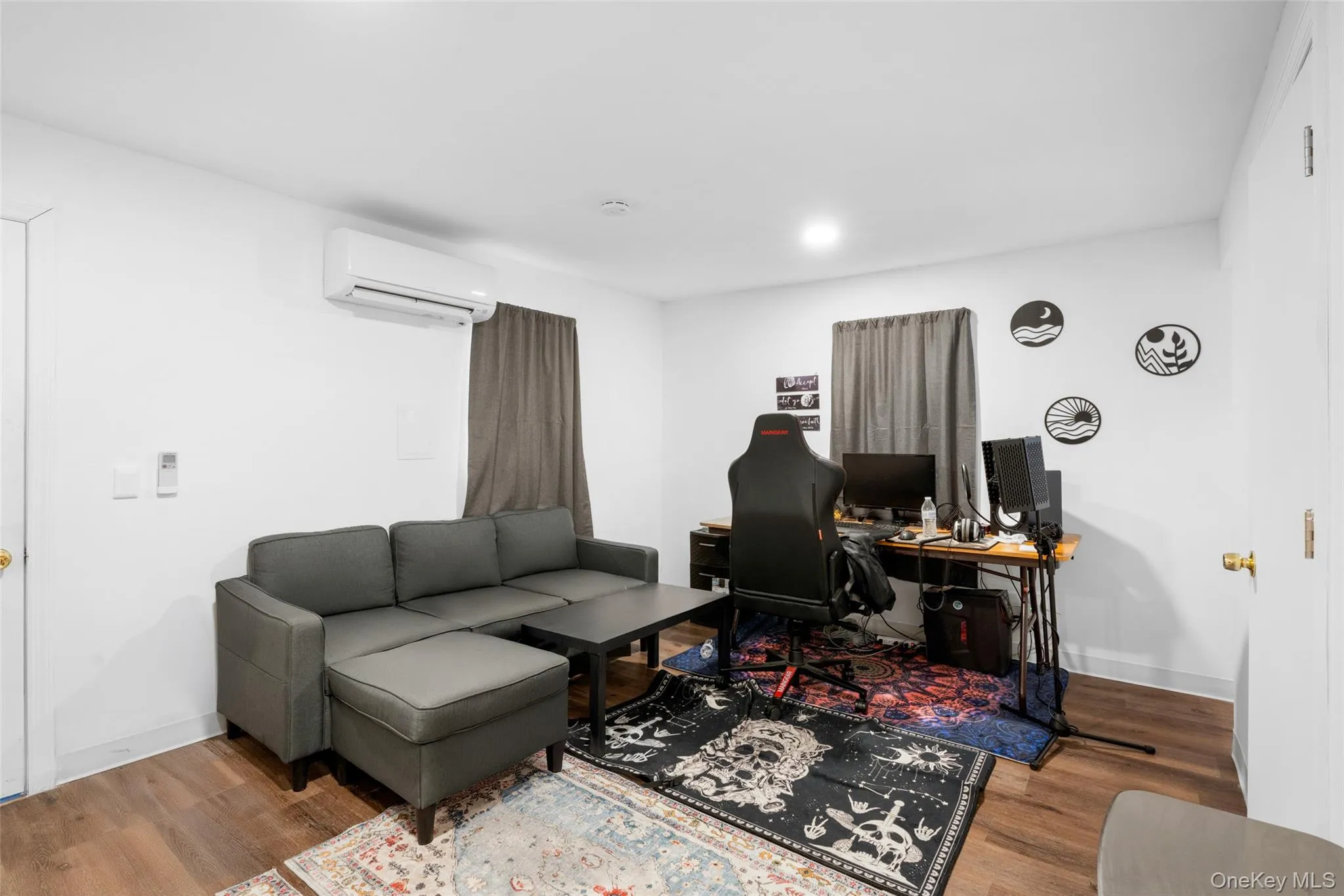 Rec room featuring hardwood / wood-style floors and a wall mounted AC Rec room featuring hardwood / wood-style floors and a wall mounted AC