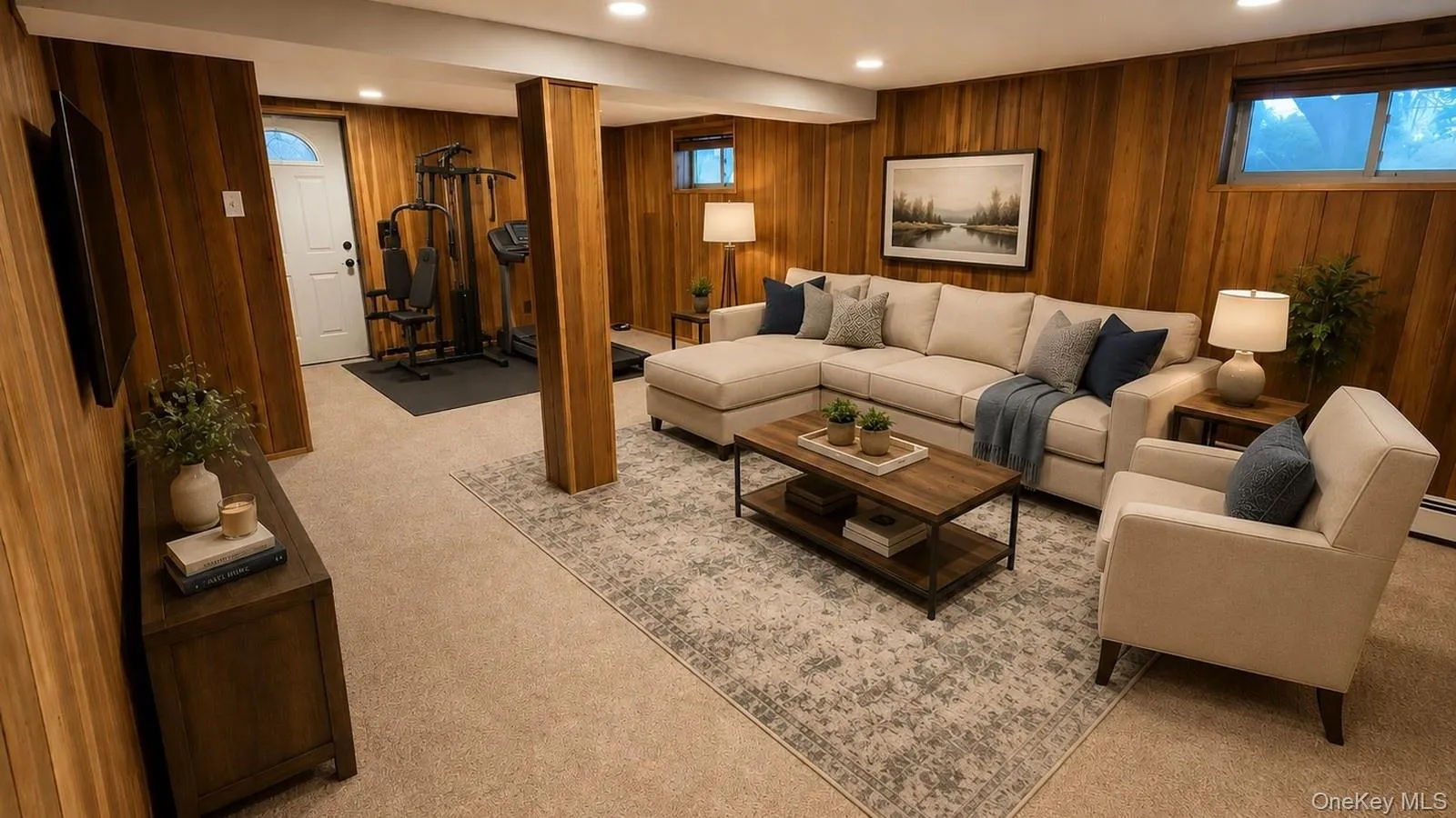 Virtually staged real estate listing photo showing the finished basement at 9 Sheep Pasture Lane in Huntington, NY 11743 as a comfortable family room with a gym area. Virtually staged real estate listing photo showing the finished basement at 9 Sheep Pasture Lane in Huntington, NY 11743 as a comfortable family room with a gym area.