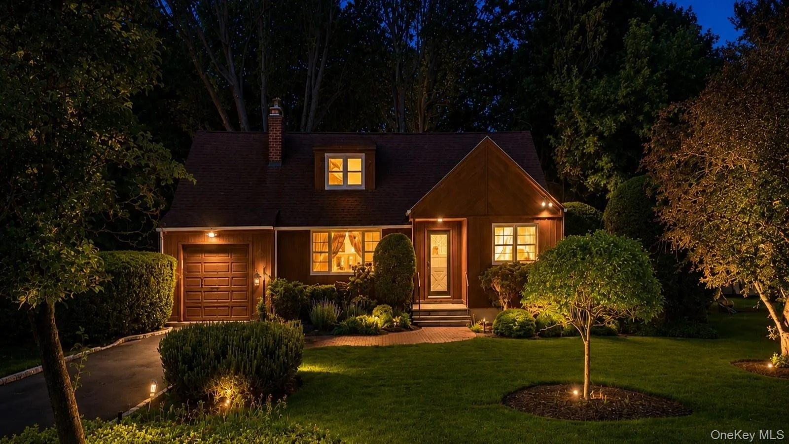Twilight real estate listing photo showing the front exterior of 9 Sheep Pasture Lane in Huntington, NY with warm interior lighting, landscape lighting, and mature trees. Twilight real estate listing photo showing the front exterior of 9 Sheep Pasture Lane in Huntington, NY with warm interior lighting, landscape lighting, and mature trees.
