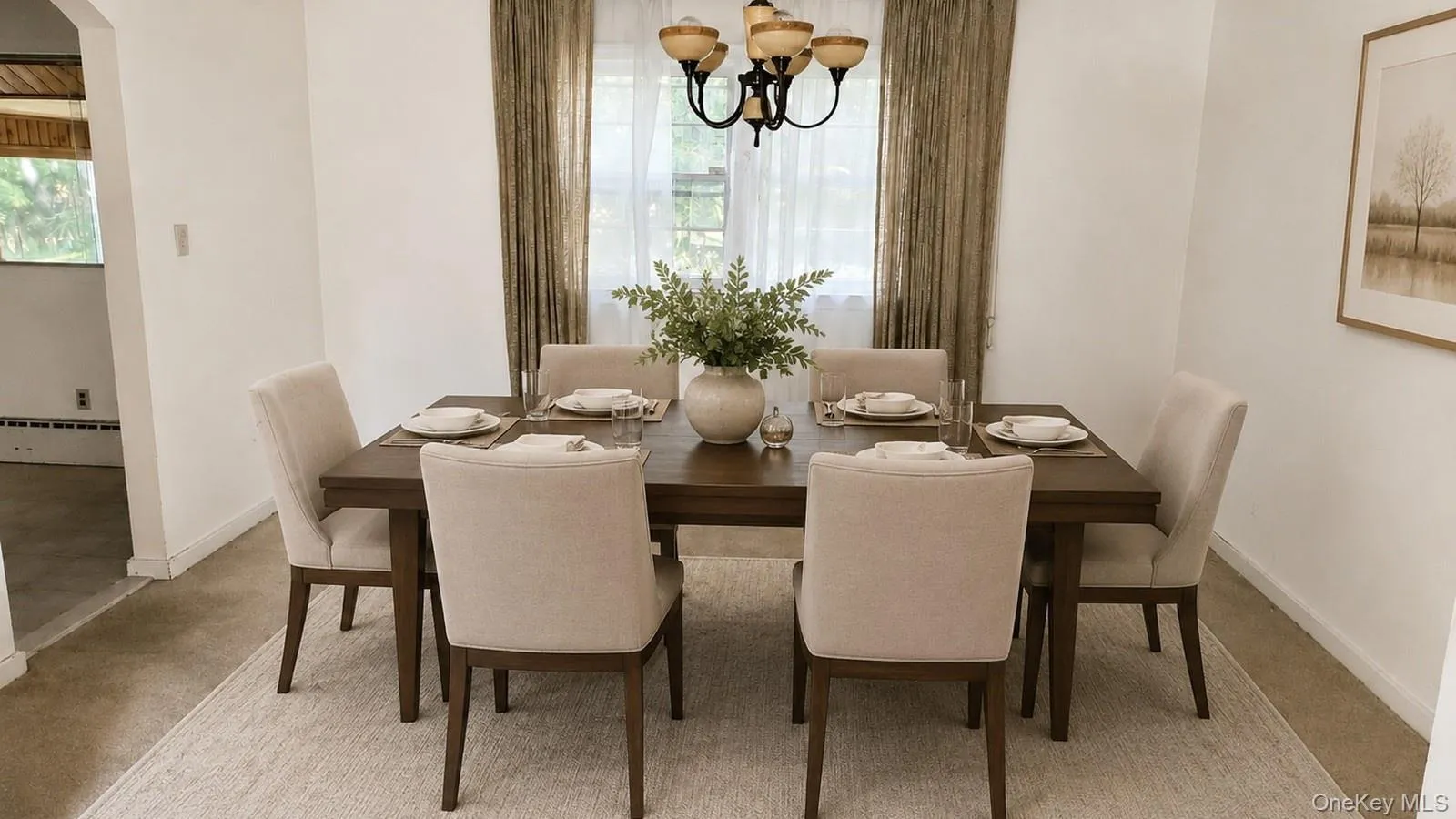 Virtually staged real estate listing photo of the dining room at 9 Sheep Pasture Lane in Huntington, NY 111743 with a six-chair dining set, chandelier, and window. Virtually staged real estate listing photo of the dining room at 9 Sheep Pasture Lane in Huntington, NY 111743 with a six-chair dining set, chandelier, and window.