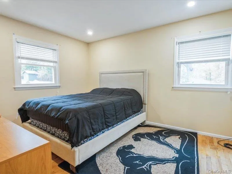 Bedroom with wood finished floors and recessed lighting Bedroom with wood finished floors and recessed lighting
