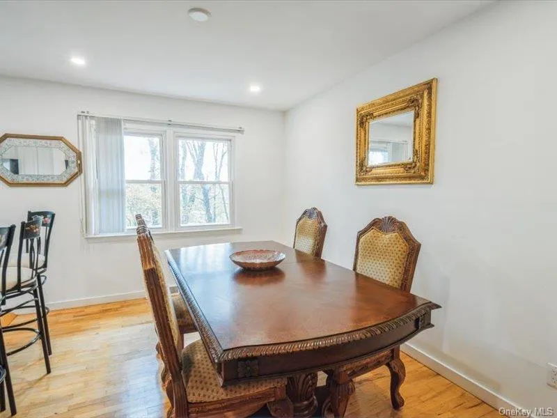 Dining area with light wood finished floors and recessed lighting Dining area with light wood finished floors and recessed lighting