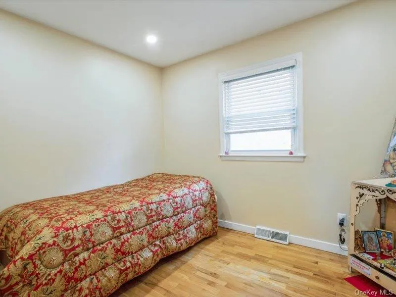 Bedroom featuring light wood-type flooring and recessed lighting Bedroom featuring light wood-type flooring and recessed lighting