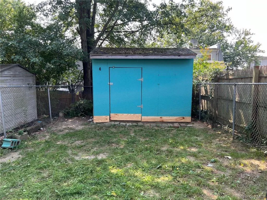View of outdoor structure featuring a yard View of outdoor structure featuring a yard
